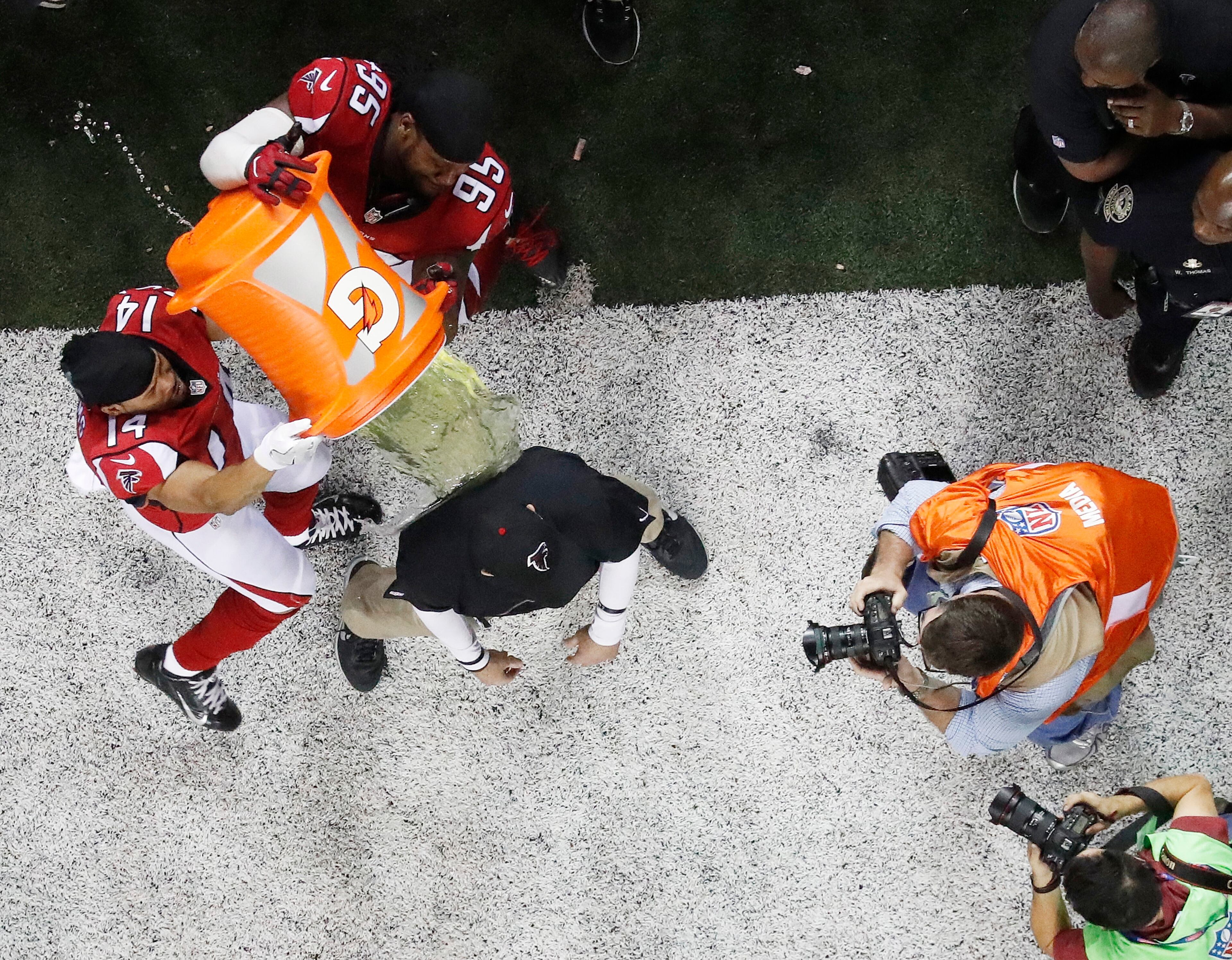 Atlanta Falcons head coach Dan Quinn reacts as he is dunked after the NFL football NFC championship game against the Green Bay Packers Sunday, Jan. 22, 2017, in Atlanta. The Falcons won 44-21 to advance to Super Bowl LI. (AP Photo/John Bazemore)