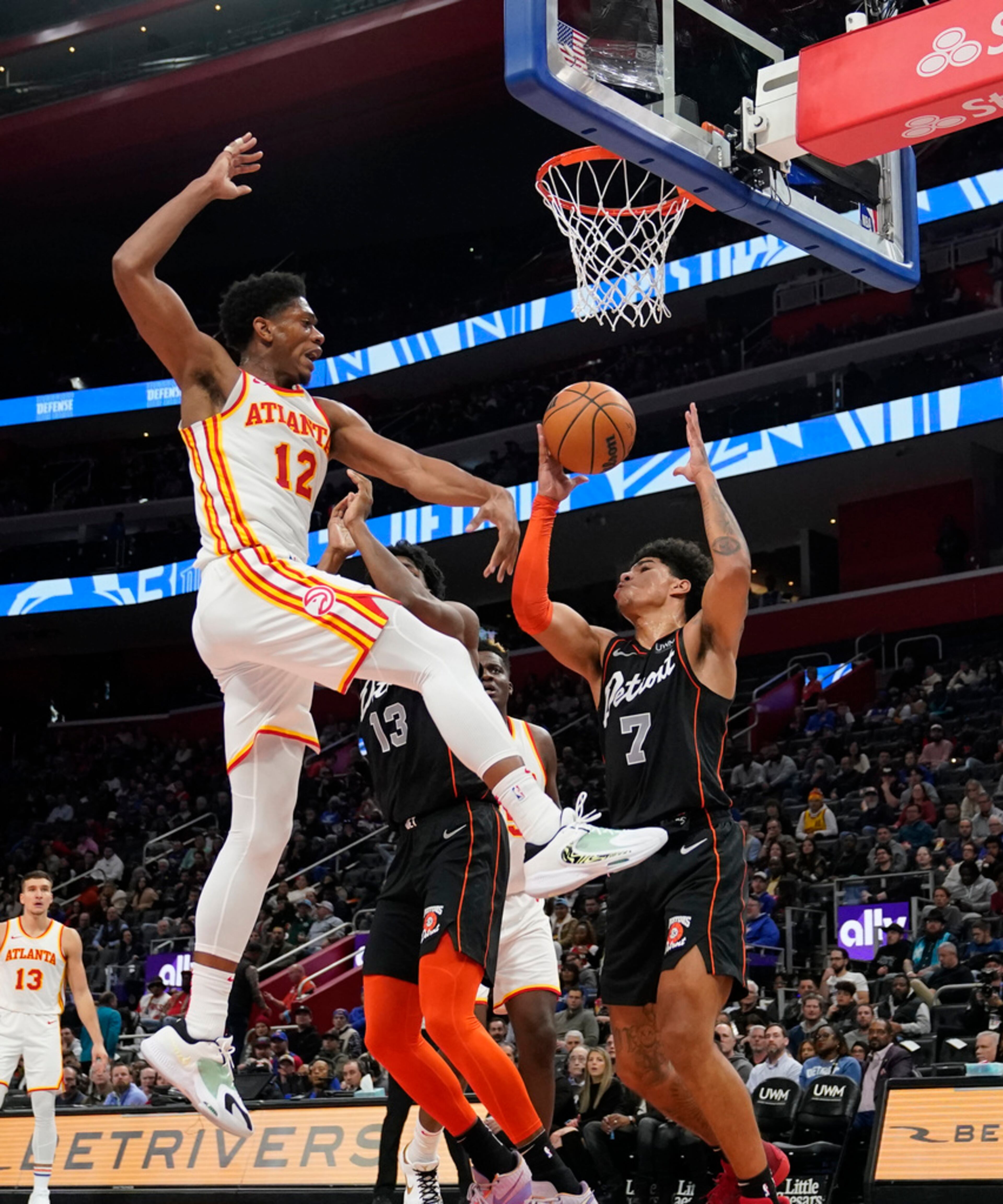 Atlanta Hawks forward De'Andre Hunter (12) loses control of the ball next to Detroit Pistons guard Killian Hayes (7) during the first half of an NBA basketball game, Tuesday, Nov. 14, 2023, in Detroit. (AP Photo/Carlos Osorio)