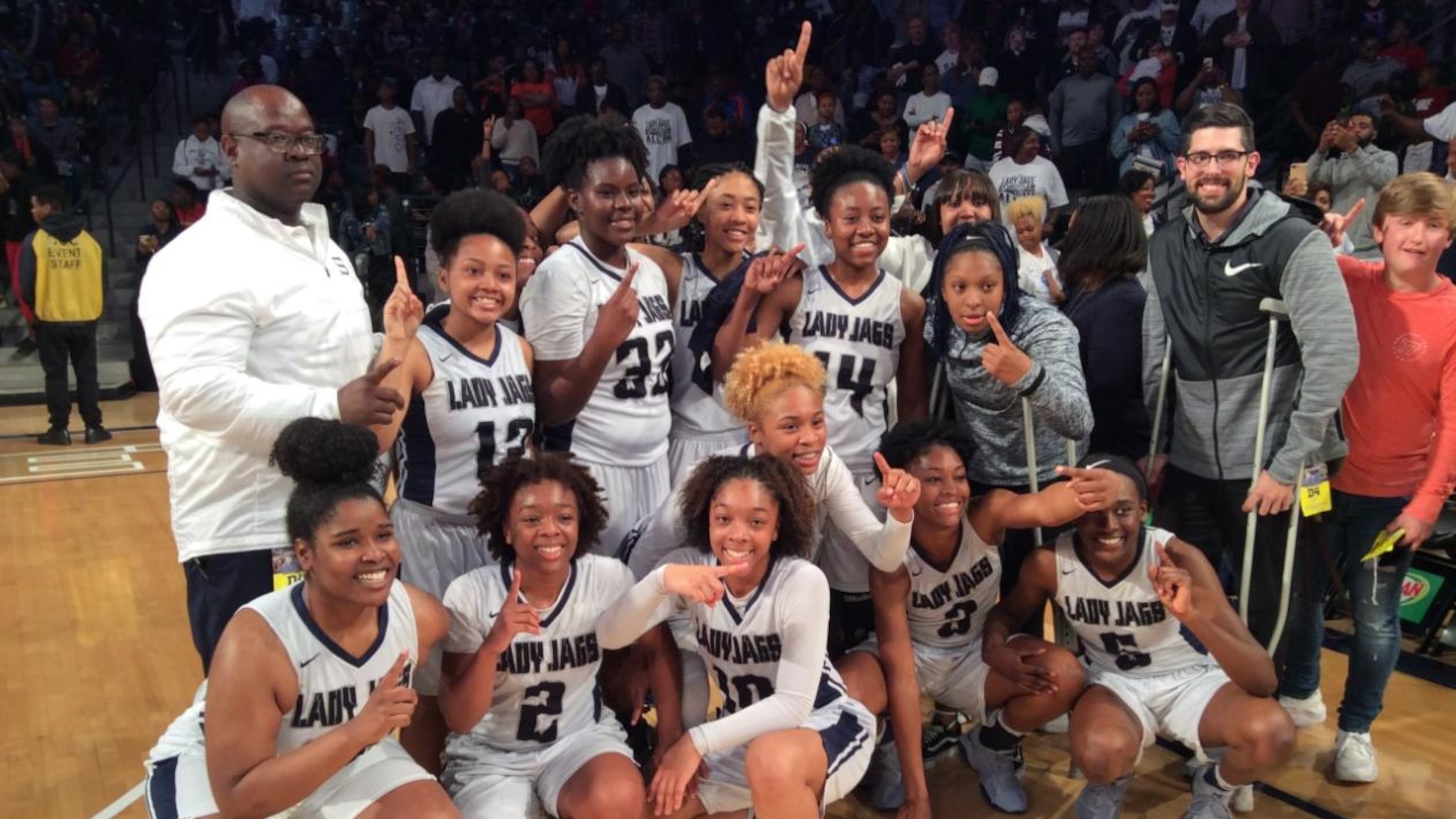 Spalding players and coaches celebrate after their 58-46 victory over Henry County in the Class AAAA girls basketball championship game on Saturday at McCamish Pavilion. (3/10/18)