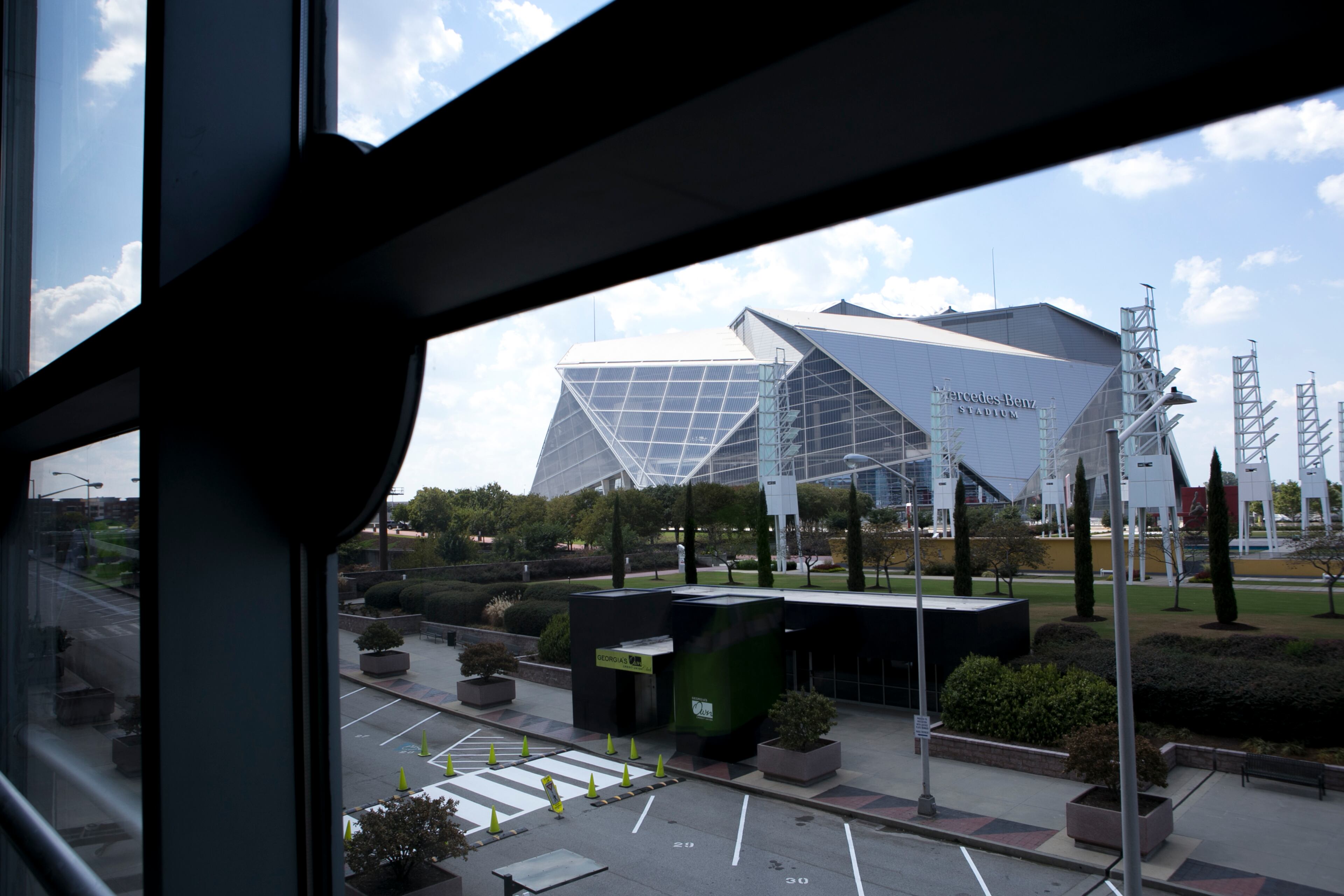 Mercedes-Benz Stadium is seen through a window during a guided media tour through the in-progress renovations at the State Farm Arena in Atlanta, Ga., on Thurs., Sept. 20, 2018. The renovations, which total $192.5 million, are on track to be completed by the arena's scheduled open house on October 20. The current rate of progress is about $1 million of work per day, according to Brett Stefansson, Atlanta Hawks executive vice president and general manager of State Farm Arena. (CASEY SYKES, CASEYLANESYKES@GMAIL.COM)