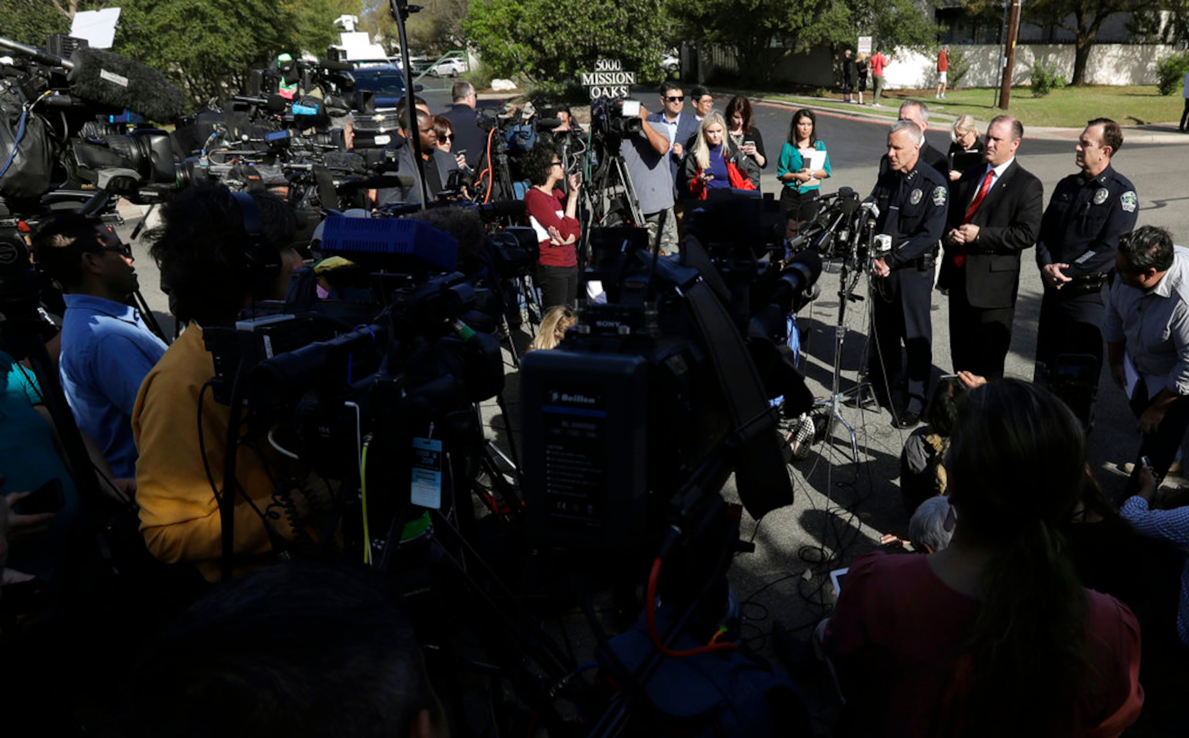 Interim Austin police chief Brian Manley, at podium, stands with Bureau of Alcohol, Tobacco, Firearms and Explosives Special Agent in Charge Fred Milanowski, FBI Special Agent in Charge Christopher Combs, and Assistant police chief Troy Gay during a news conference near the site of Sunday's explosion, Monday, March 19, 2018, in Austin, Texas. Fear escalated across Texas' capital city on Monday after the fourth bombing this month, a blast that was triggered this time by a tripwire, demonstrating what police called a "higher level of sophistication" than the package bombs used in the previous attacks.