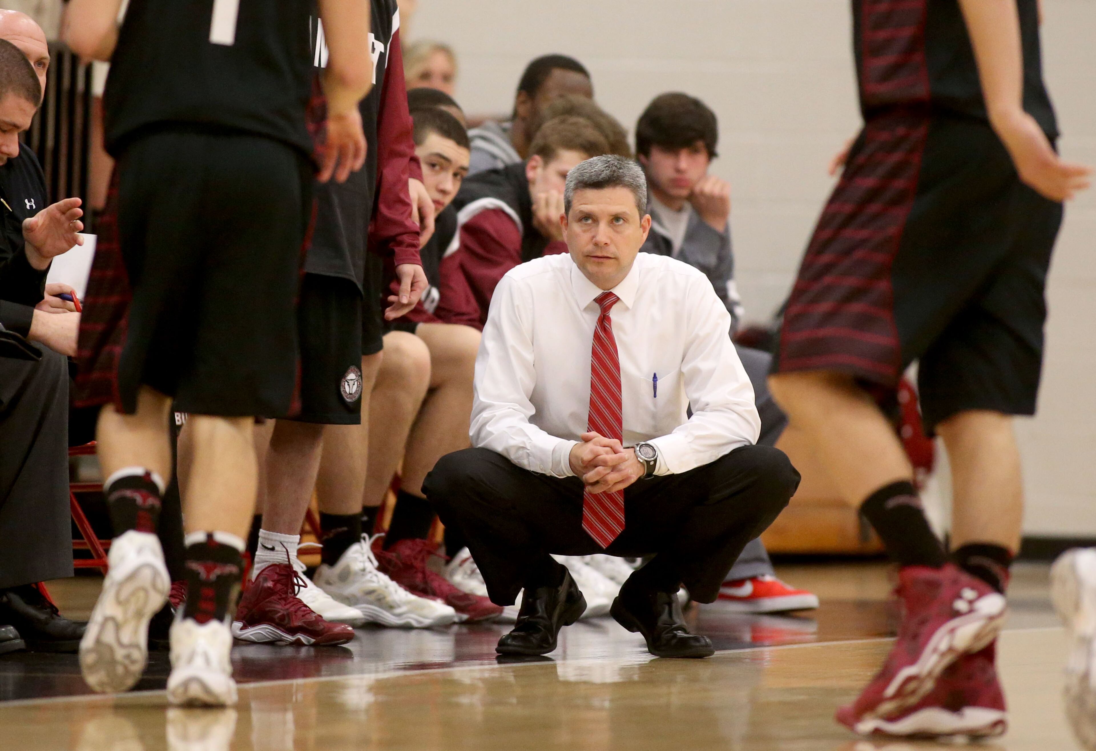 Lambert coach Scott Bracco, center, is shown on the sideline during their loss to North Gwinnett Tuesday night in Suwanee, Ga., February 25, 2014. North Gwinnett defeated Lambert 74-48 in the second round of the Class AAAAAA state basketball tournament.