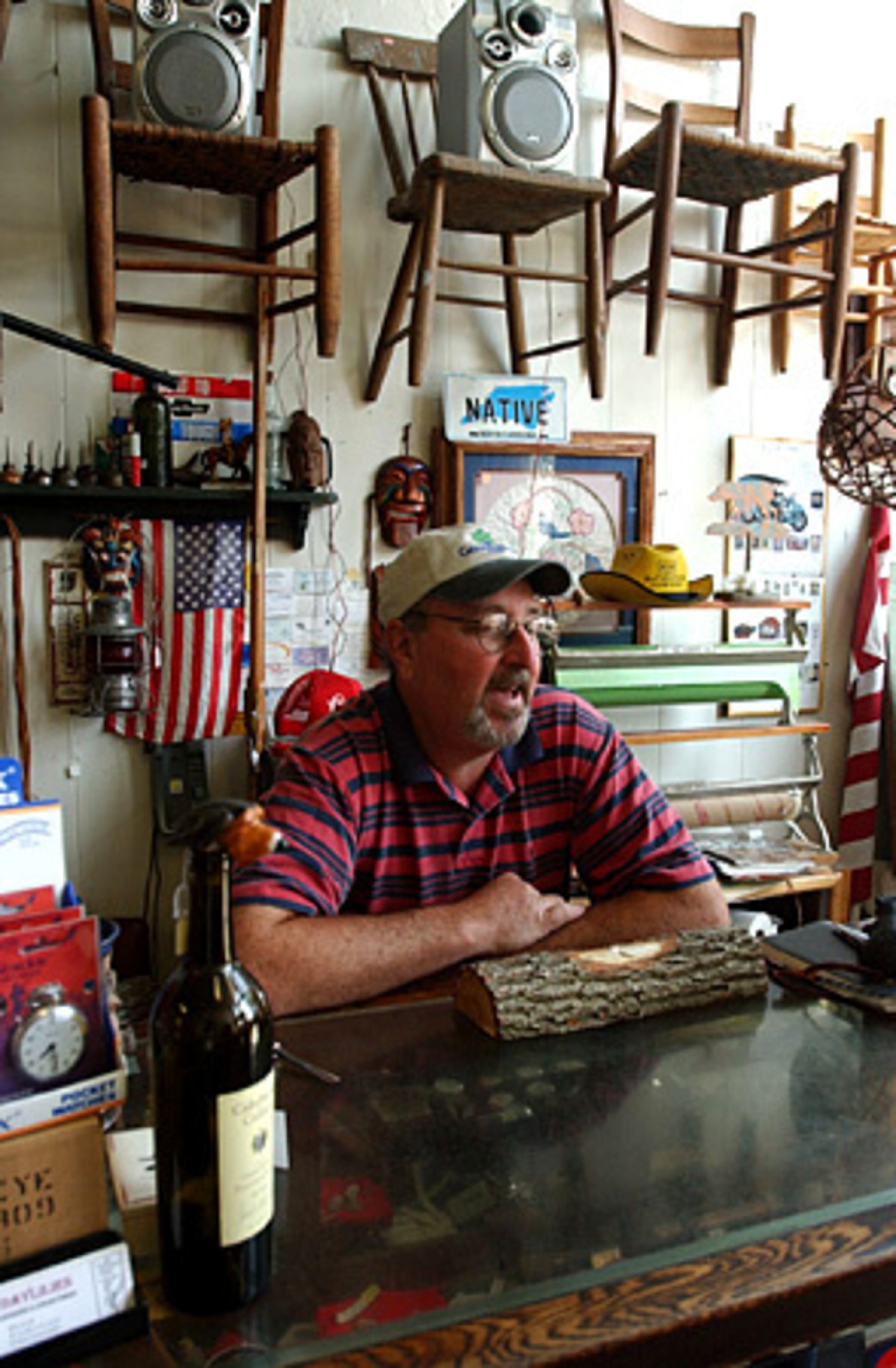 In downtown Murphy, Dayliles Antiques and Collectibles store owner Bob Crisp works on a carving a week after Rudolph was caught.