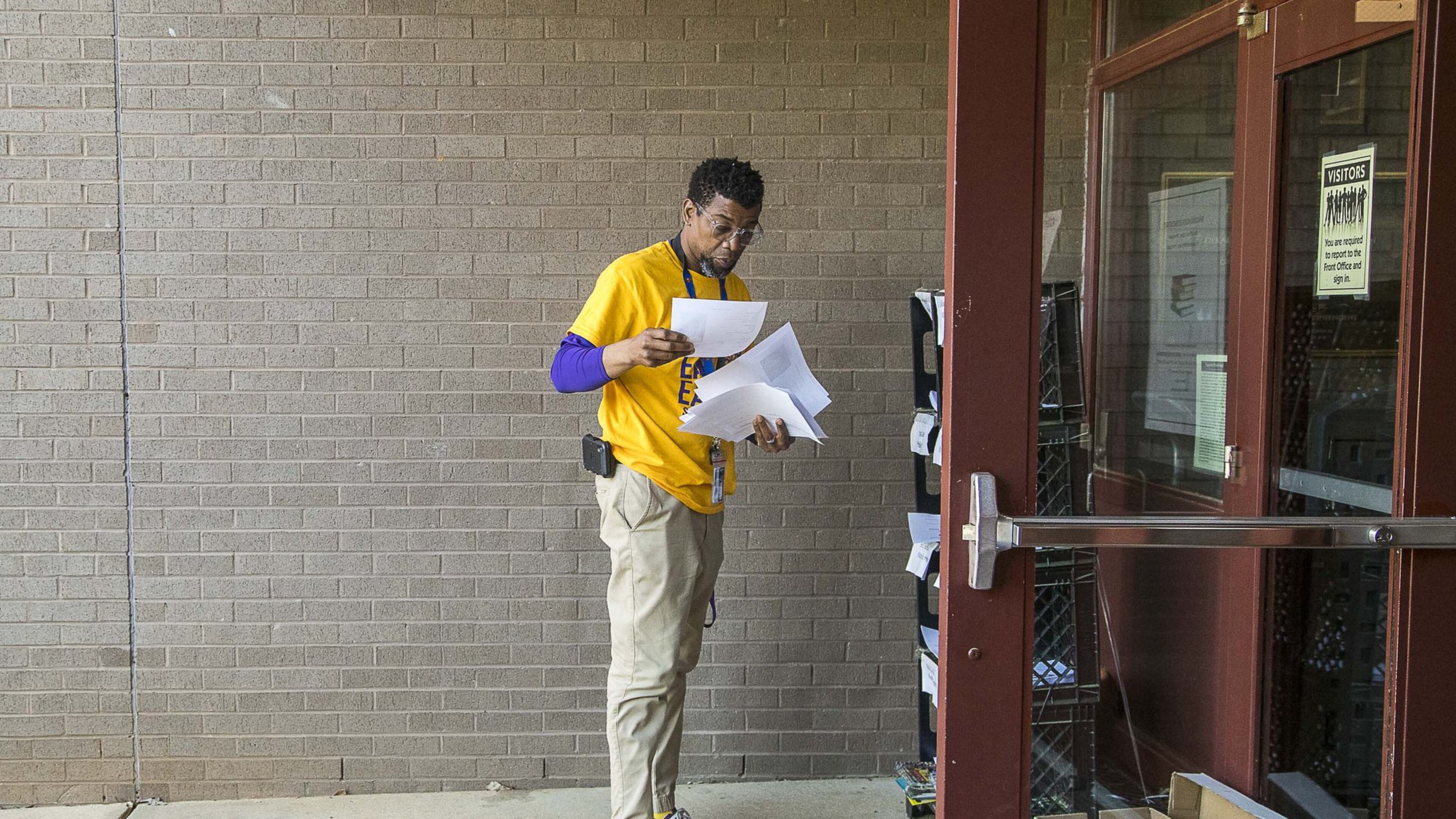 Shadow Rock Elementary School principal Ethan Suber collects packets of school work for drop-offs at the school in Lithonia, Monday, April 27, 2020. Each week Suber works with assistant principal Jason Moffitt to print out classwork for more than 100 students who do not have access to a computer or the internet. The classwork is filed in bins and left outside for parents and guardians to pick-up. A bin for completed work is also available to help teachers keep up with all of their students’ work. ALYSSA POINTER / ALYSSA.POINTER@AJC.COM