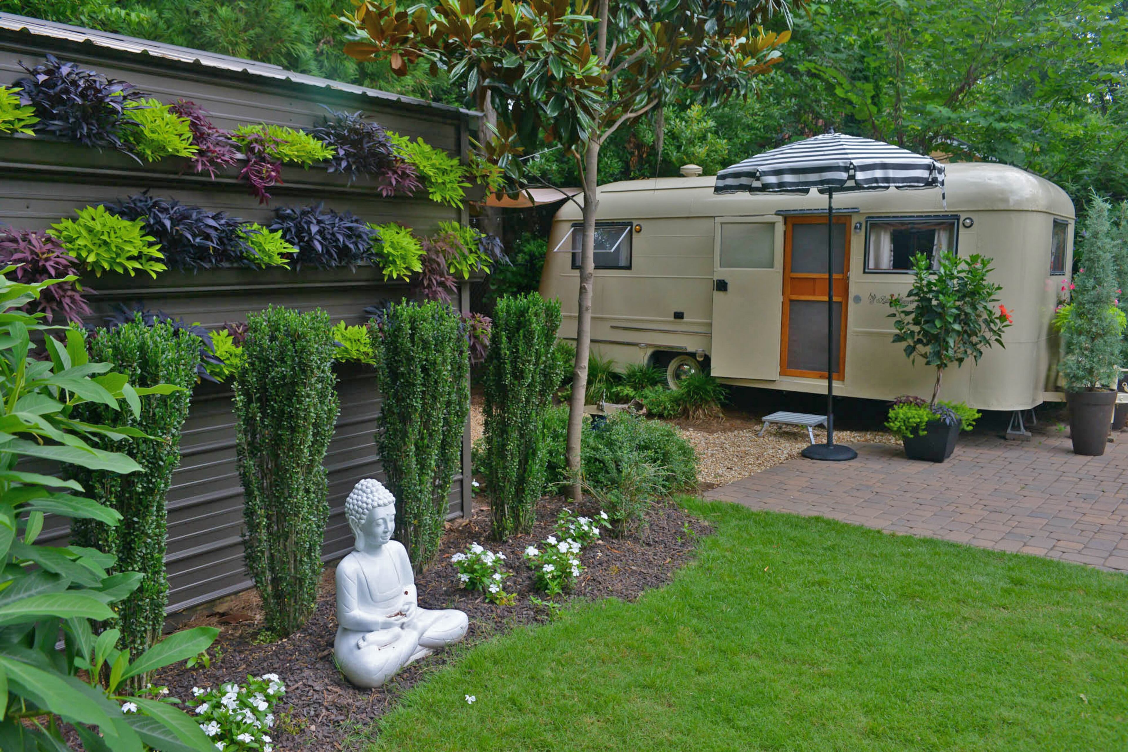 On her backyard storage shed, Barbara English installed a gutter garden. She planted sweet potato vine in the gutters, which hang down over the sides, camouflaging the shed so that it becomes part of the garden. “It becomes a living wall,” she said.