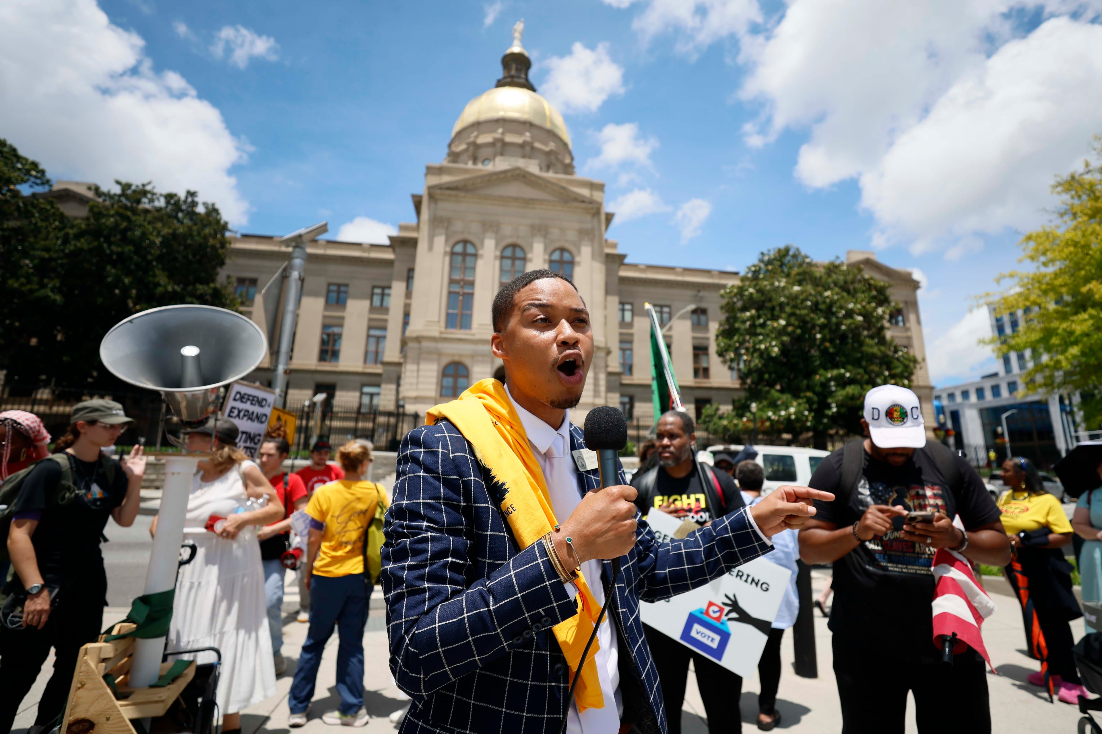 State Rep. Eric Bell, D-Jonesboro, speaks to participants at a rally outside the State Capitol after announcing that Georgia Republican leaders will not redraw the state’s political maps during a special legislative session on Wednesday, June 17, 2026.
(Miguel Martinez/AJC)