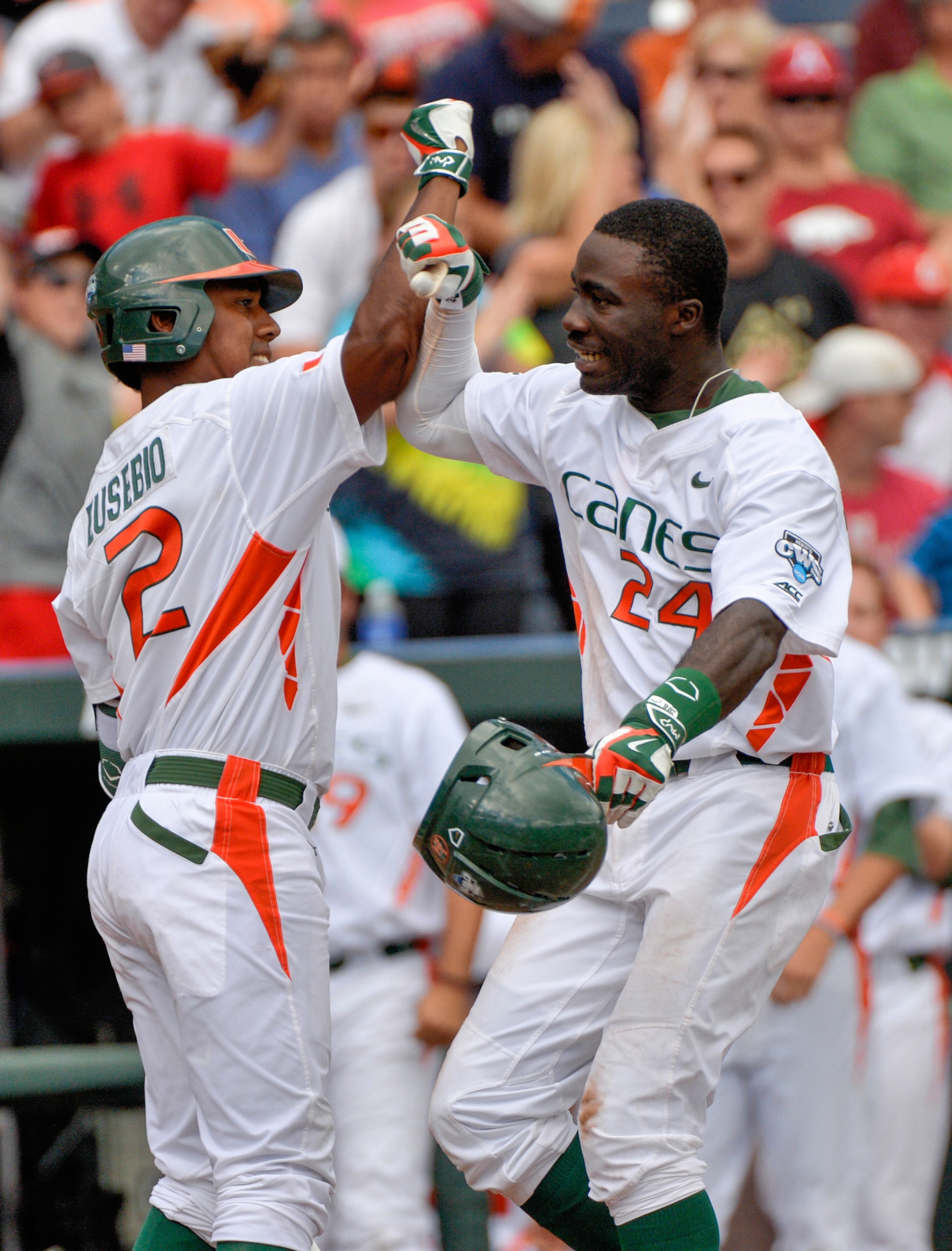 Miami's Jacob Heyward (right) is welcomed by Ricky Eusebio after his two-run home run