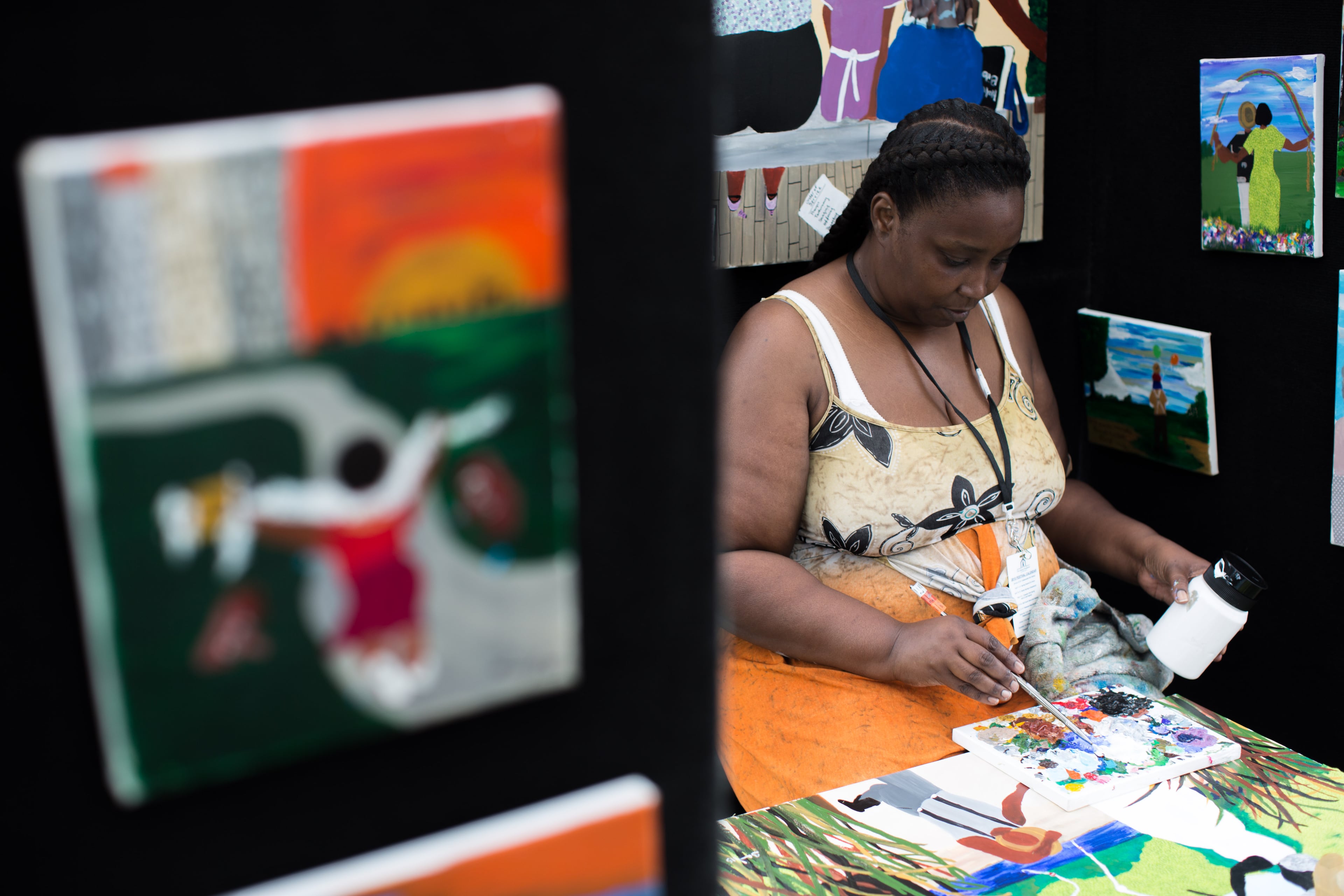 Artist Sandy Hall paints on a canvas during the Old Fourth Ward Park Arts Festival, Saturday, June 27, 2015, in Atlanta. BRANDEN CAMP/SPECIAL