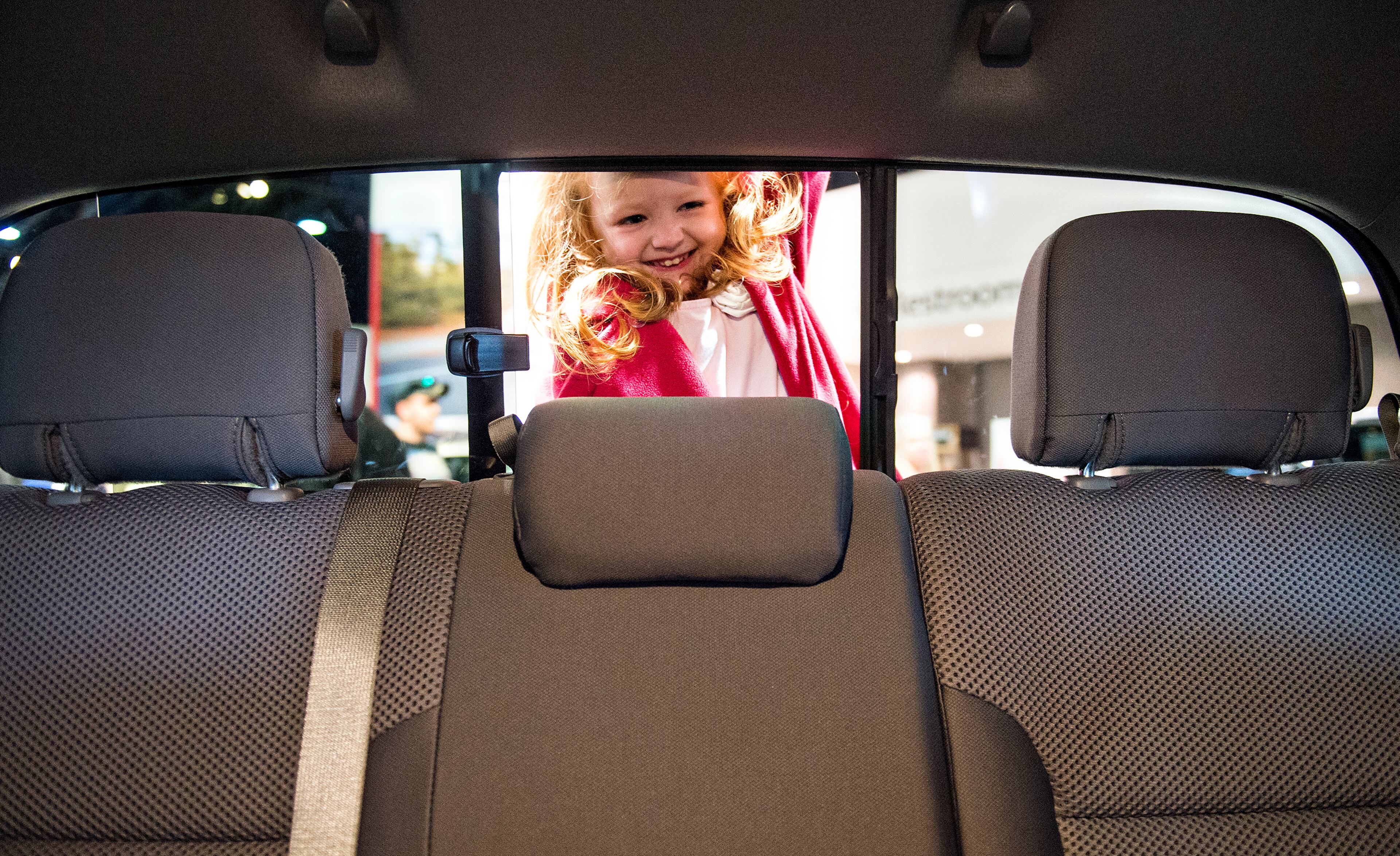 March 29, 2015 Atlanta - Meredith Koues peeks through the back window of a Toyota Tacoma during the Atlanta International Auto Show at the Georgia World Congress Center on Sunday, March 29, 2015. The four day show featured automobiles from 29 different manufacturers including Jeep, Chevrolet, Alfa Romeo, Lexus, BMW, Nissan, Volkswagen and more. JONATHAN PHILLIPS / SPECIAL