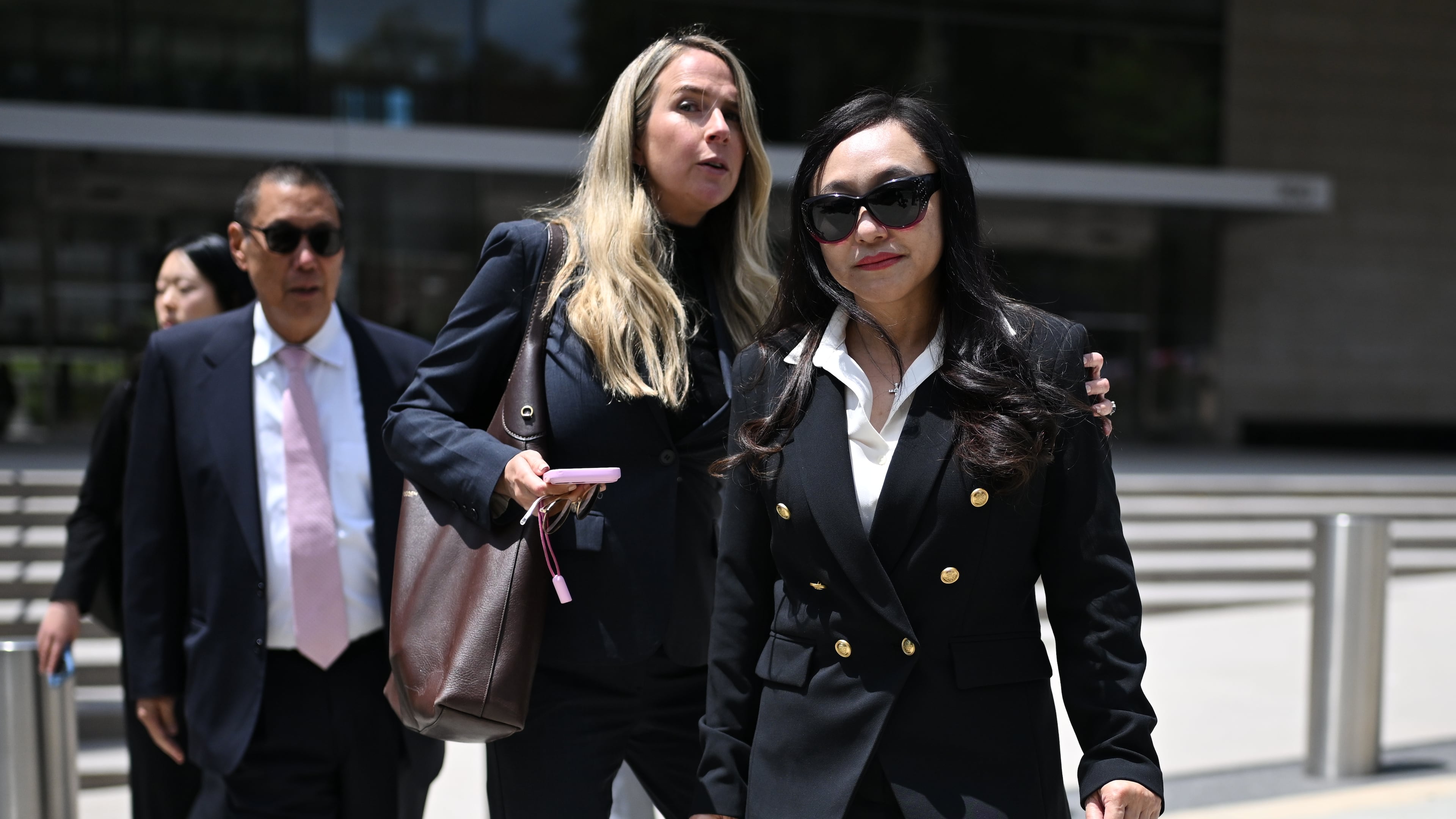 Eileen Wang, the former mayor of Arcadia, Calif., at right, exits federal court after pleading guilty on charges of acting as an illegal agent for the Chinese government on Friday, May 29, 2026, in Los Angeles. (AP Photo/William Liang)