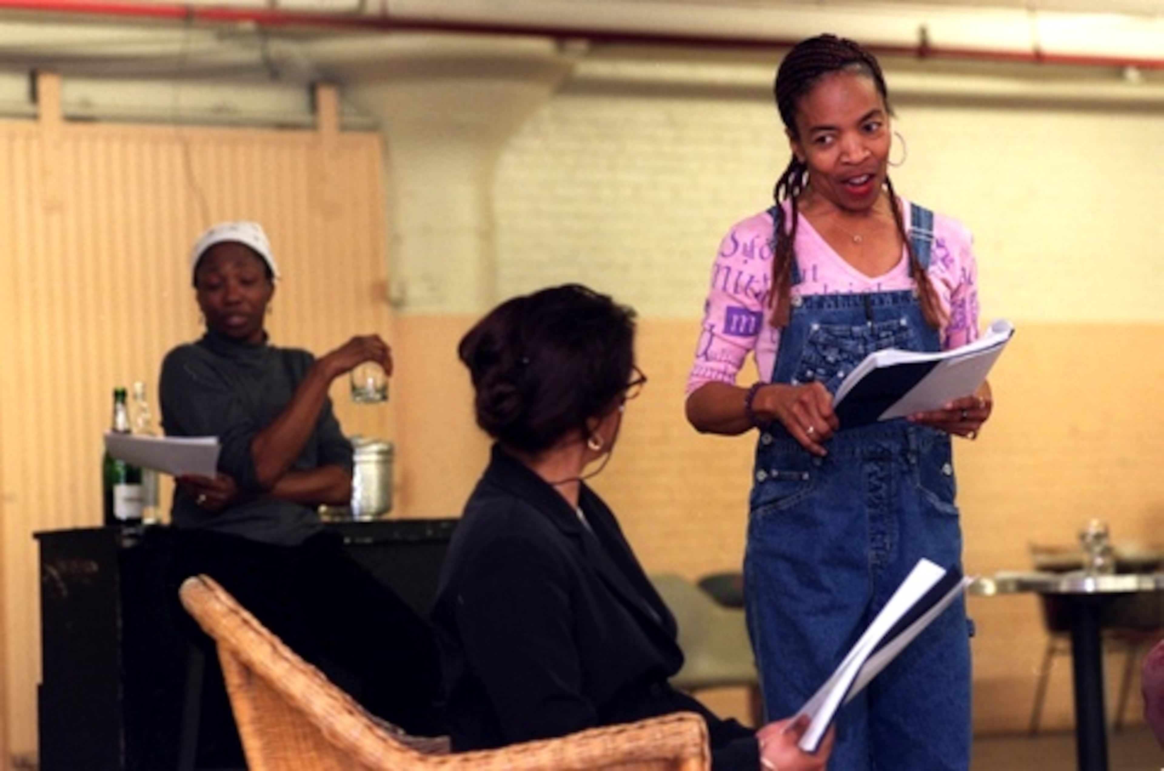 Actors Margo Moorer (left), Joyce Sylvester, and Carol Mitchell-Leon (right) rehearse 'Dance on Widow Row,' which was performed by New Jomandi Productions in April 2002.
