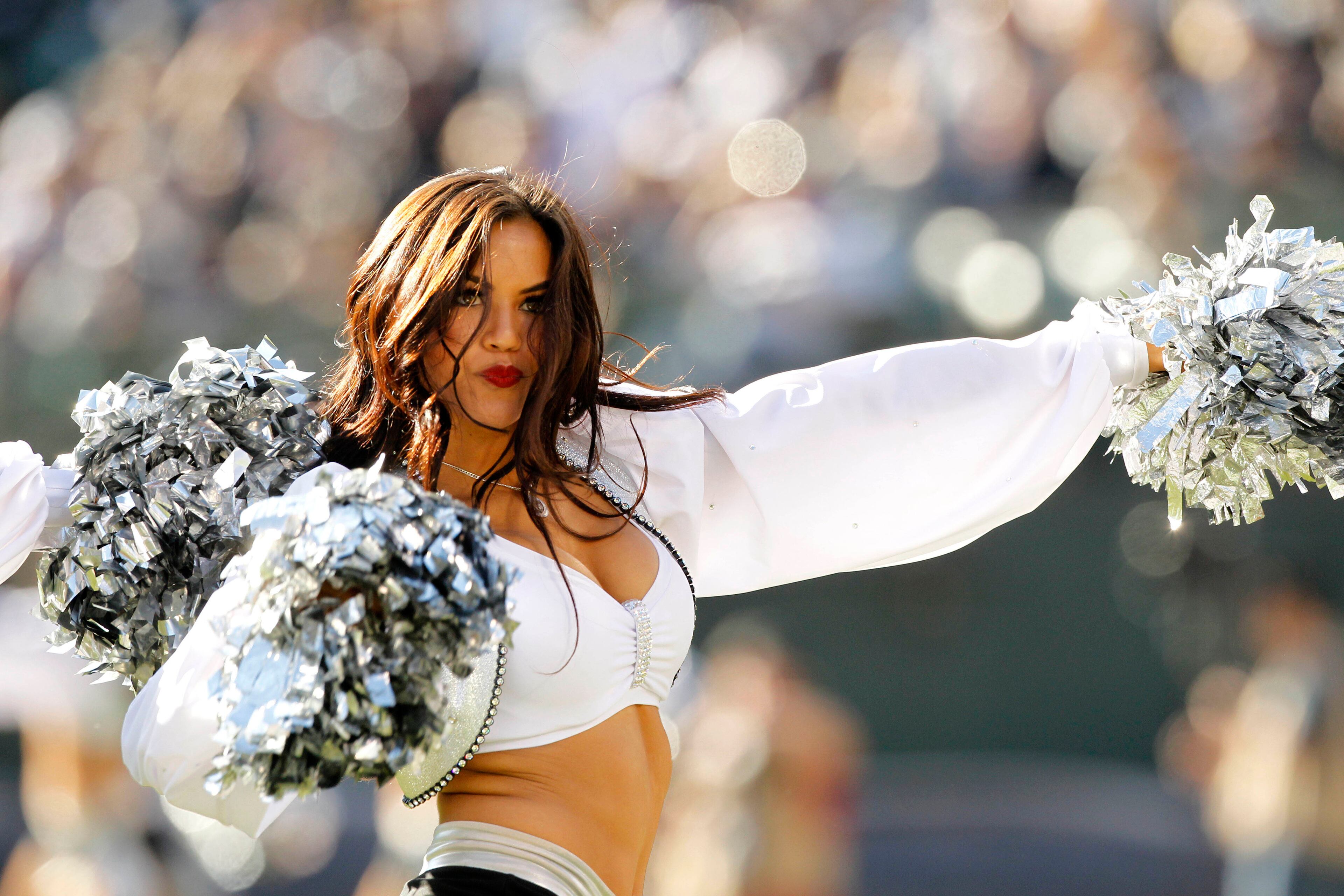 An Oakland Raiders cheerleader from the raiderettes squad performs during a timeout against the Tennessee Titans in the first quarter at O.co Coliseum. The Titans defeated the Raiders 23-19. Mandatory Credit: Cary Edmondson-USA TODAY Sports