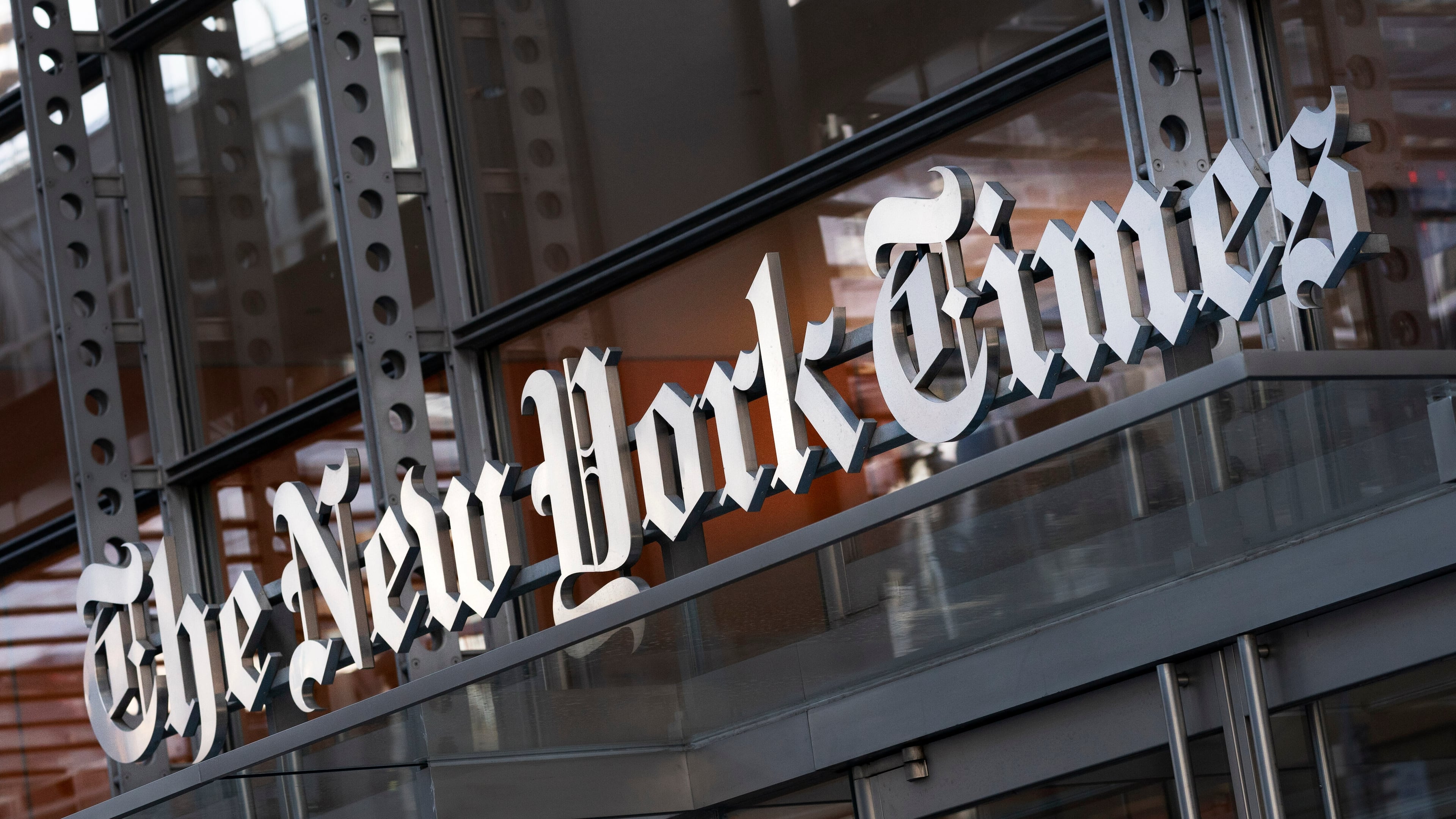 FILE - A sign for The New York Times is displayed above the entrance to its building in New York on May 6, 2021. (AP Photo/Mark Lennihan, File)