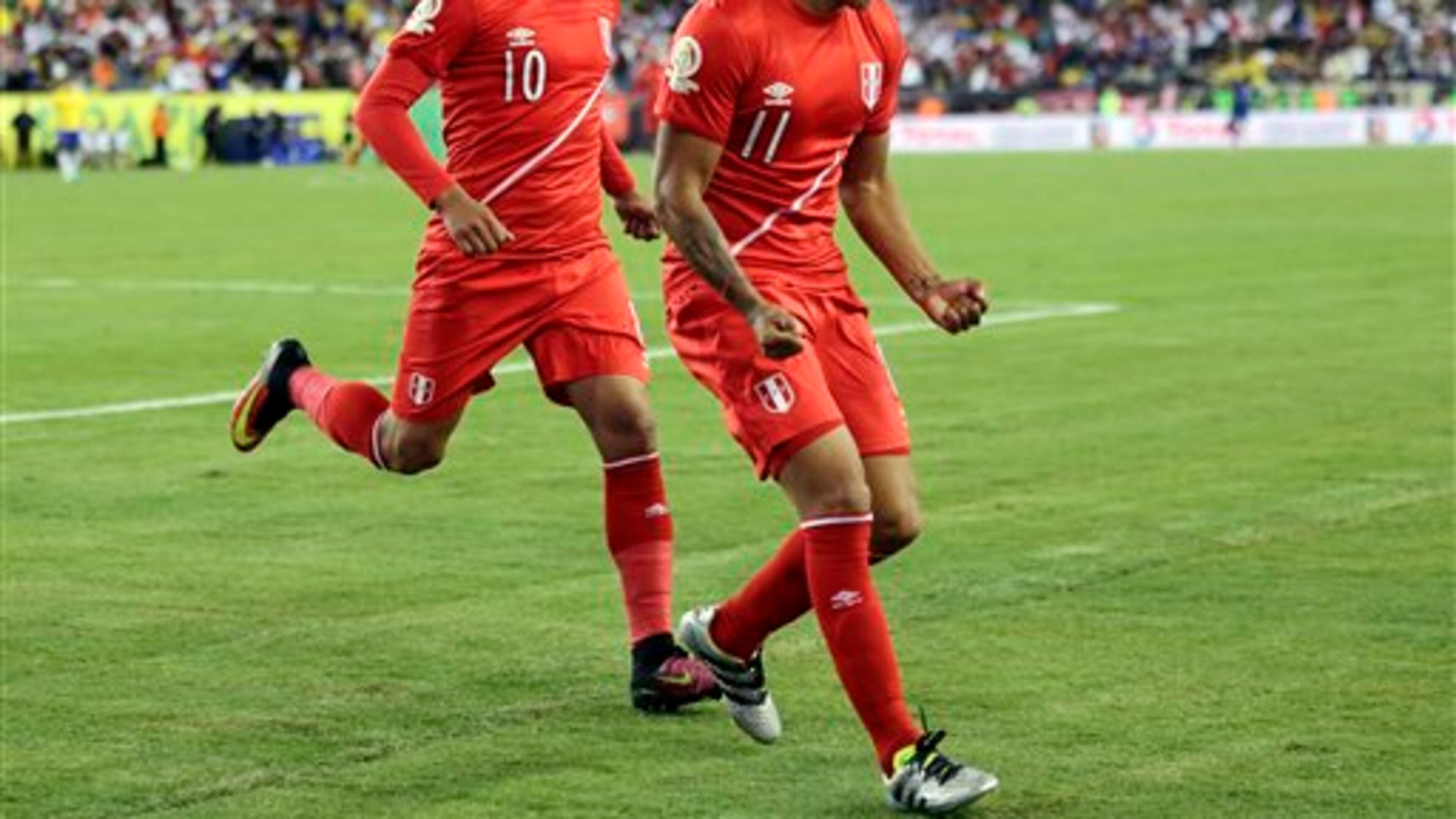 Peru's Raul Ruidiaz (11) celebrates his goal against Brazil with Christian Cueva (10) in the second half of a Copa America Group B soccer match on Sunday, June 12, 2016, in Foxborough, Mass. (AP Photo/Charles Krupa)