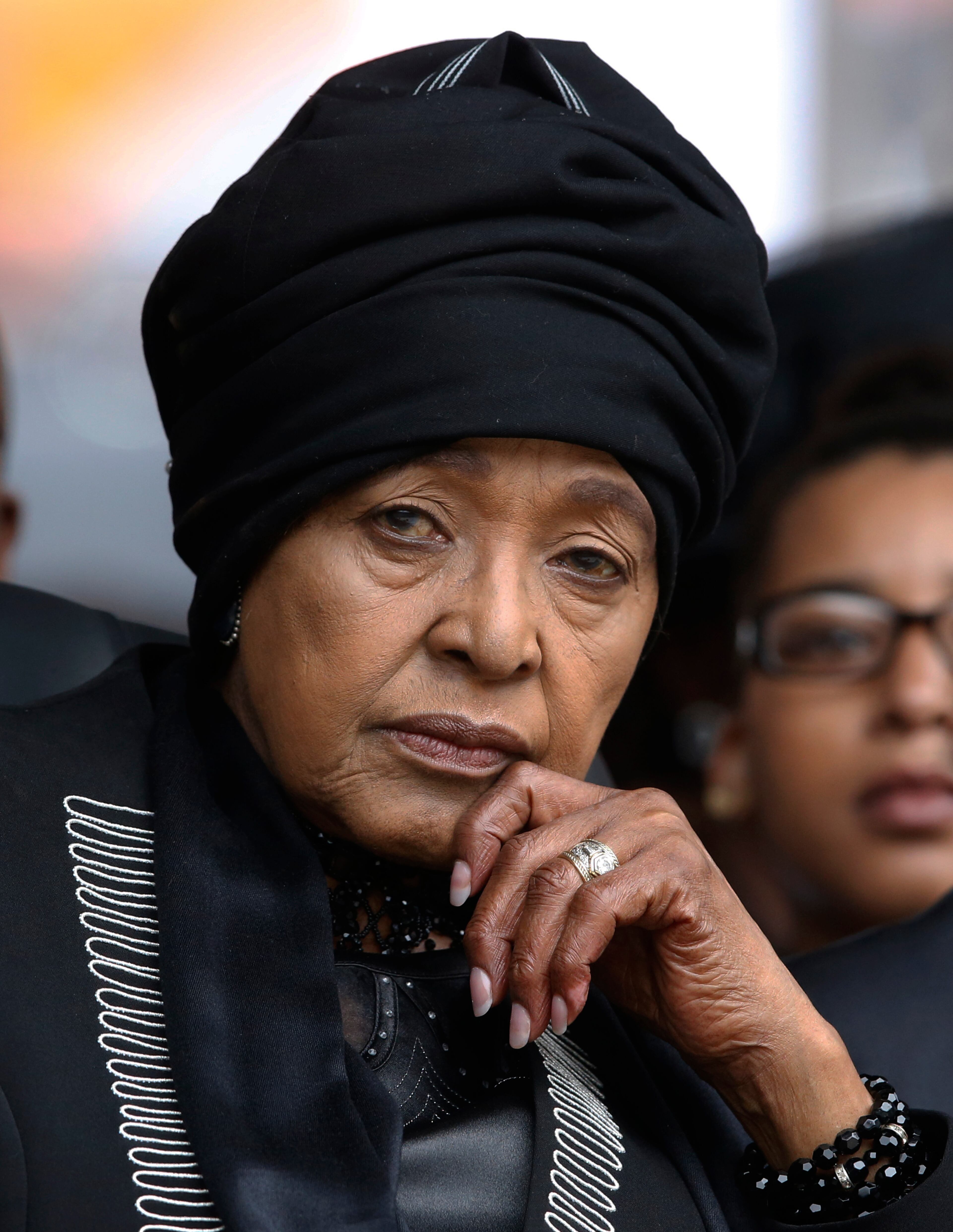 Winnie Madikizela-Mandela, Nelson Mandela's former wife, listens to speakers during the memorial service for former South African president Nelson Mandela at the FNB Stadium in Soweto near Johannesburg, Tuesday, Dec. 10, 2013
