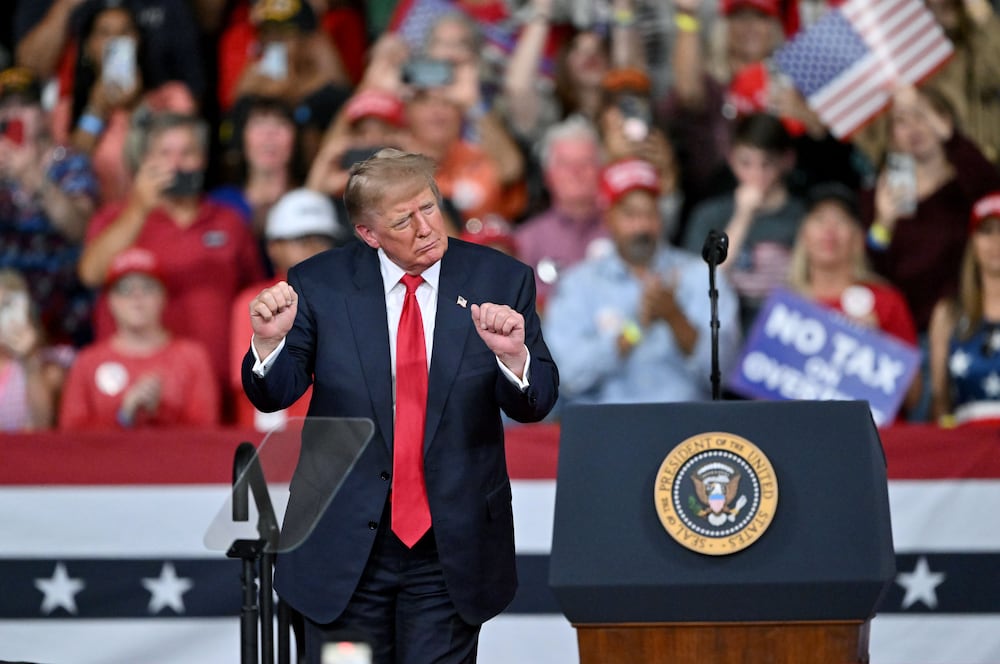 President Donald Trump dances at the end of a midterm campaign rally at Guardian Centers in Perry on Saturday. (Hyosub Shin/AJC)
