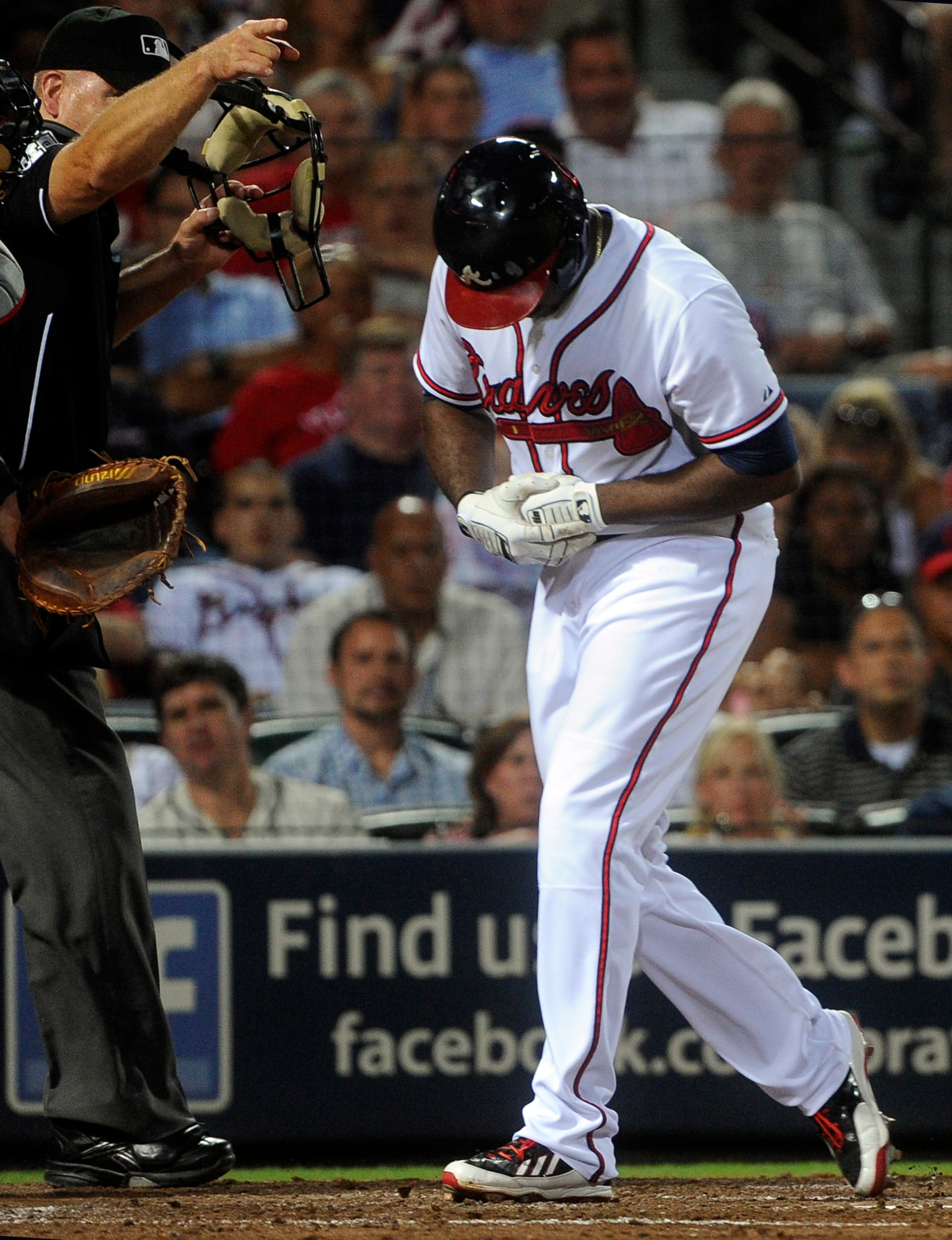 Atlanta Braves' Justin Upton, right, reacts after being hit by a pitch by starting pitcher Ubaldo Jimenez during the fifth inning of a baseball game on Thursday, Aug. 29, 2013, in Atlanta. Upton came out of the game on the play. (AP Photo/John Amis)