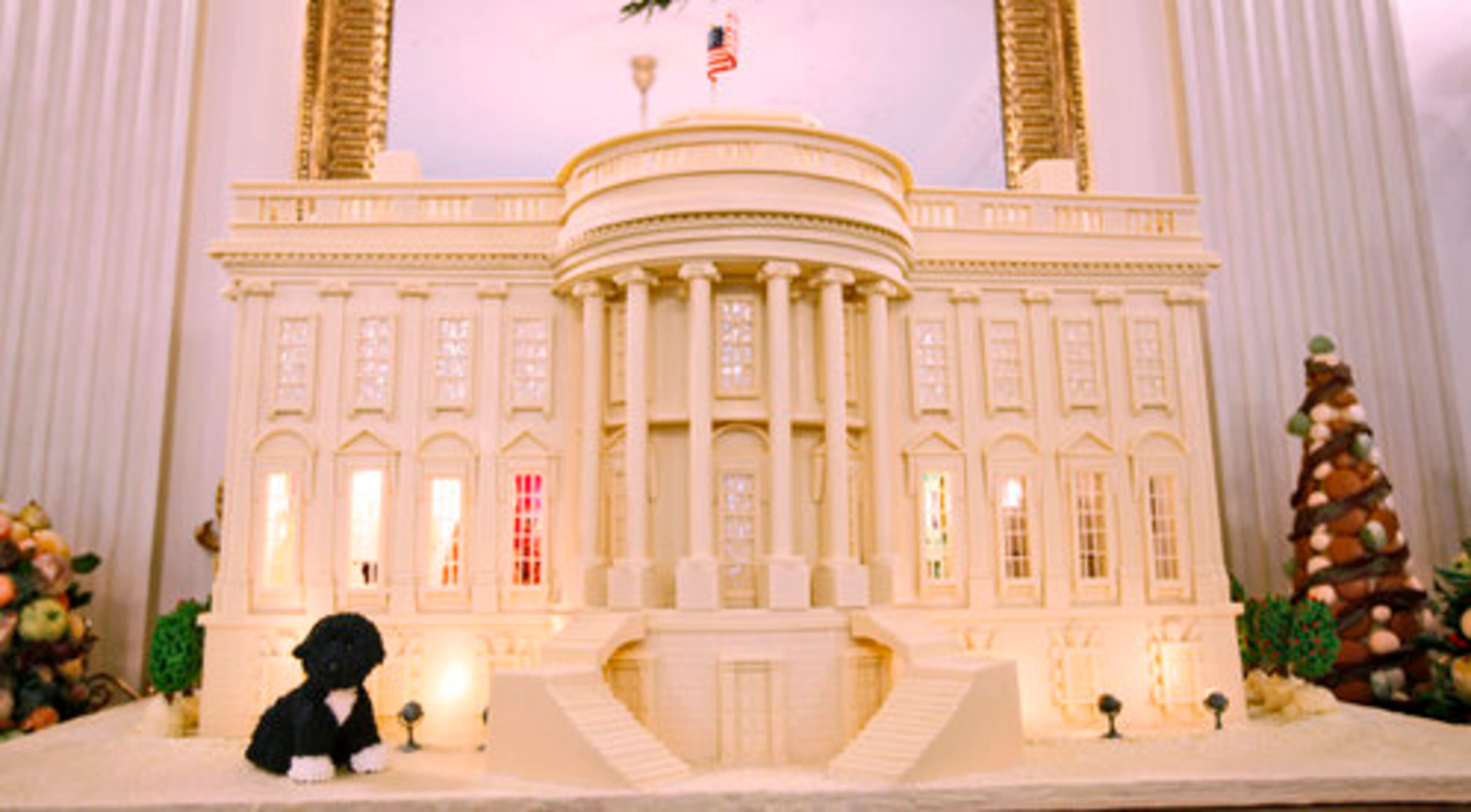 A White House gingerbread house, weighing about 400 pounds, features a marzipan "Bo" is displayed in the State Dining Room.