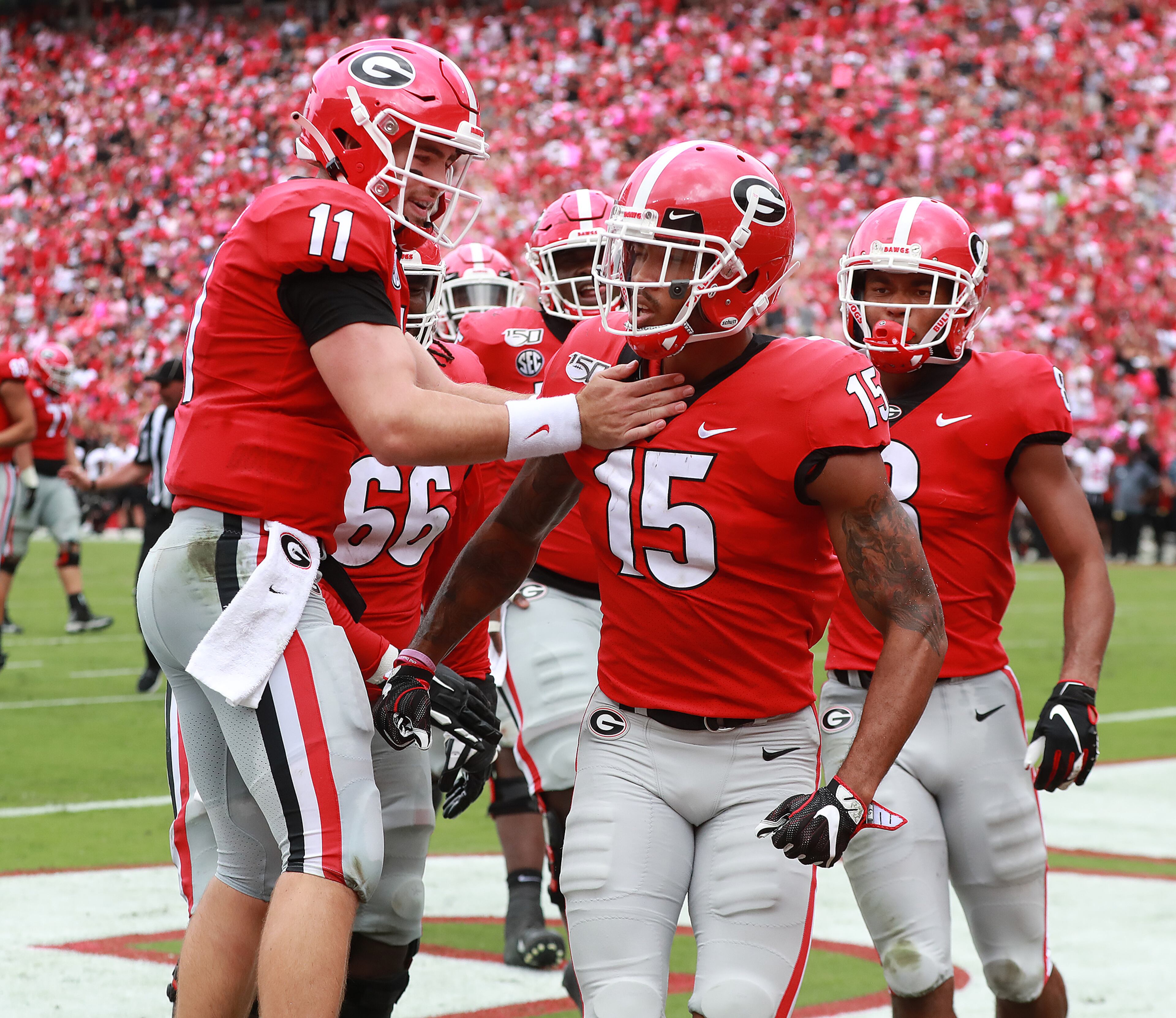 Georgia wide receiver Lawrence Cager (15) and quarterback Jake Fromm celebrate Cager's touchdown catch for a 34-0 lead. Curtis Compton/ccompton@ajc.com