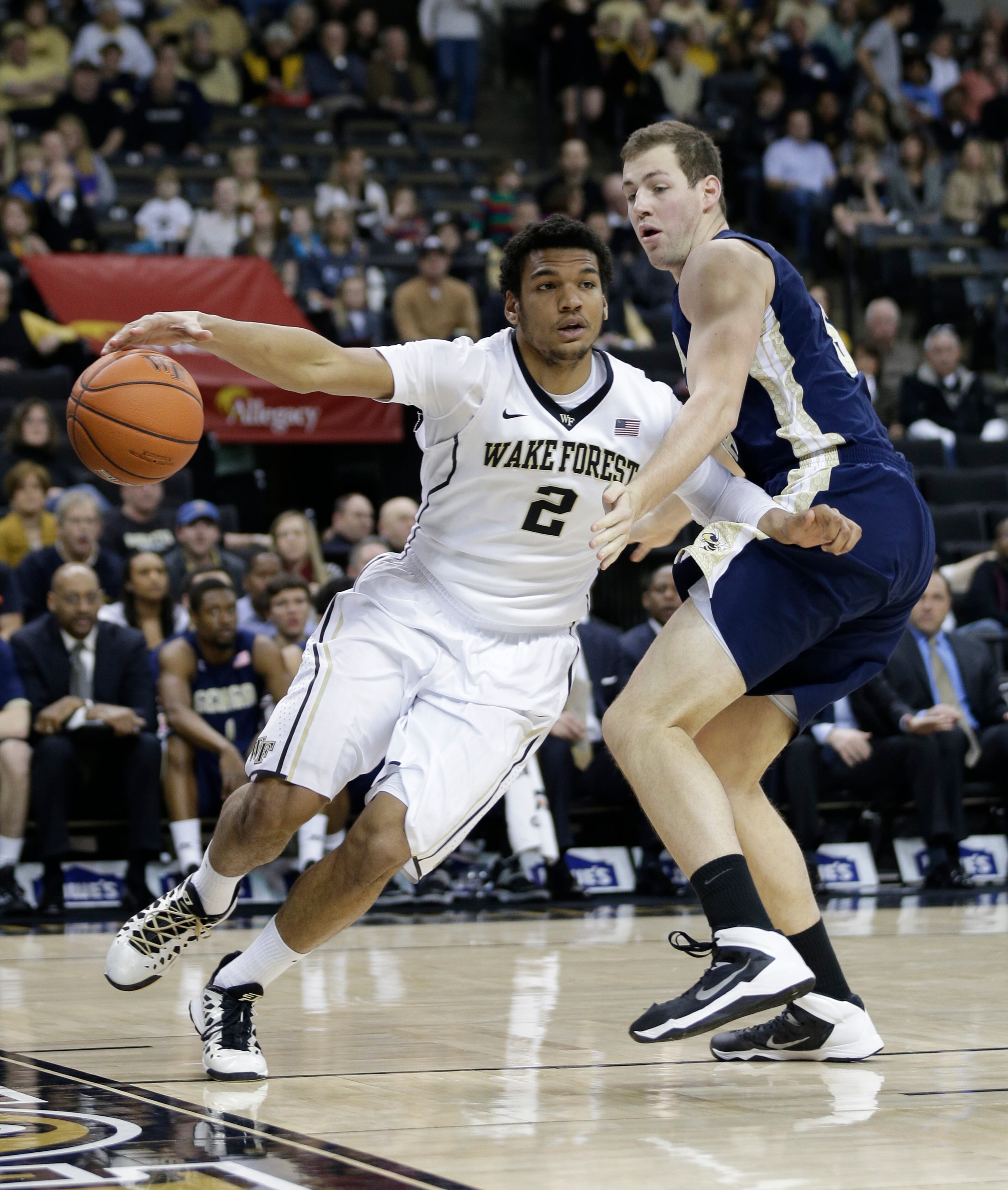 Wake Forest's Devin Thomas (2) drives past Georgia Tech's Daniel Miller (5) during the first half of an NCAA college basketball game in Winston-Salem, N.C., Saturday, Feb. 1, 2014.