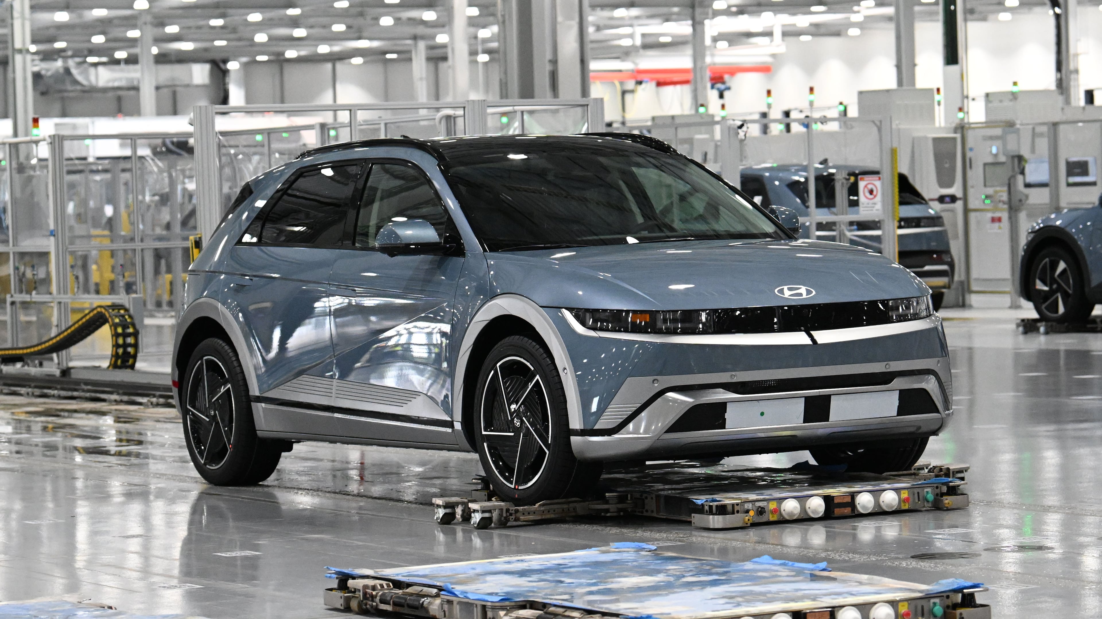 Electric vehicles are transported by autonomous mobile robots through the assembly line at the Hyundai Motor Group Metaplant America on Wednesday, May 6, 2026, in Ellabell. The Korean auto giant is evaluating plans to increase the annual production capacity at its plant near Savannah. (Hyosub Shin/AJC)