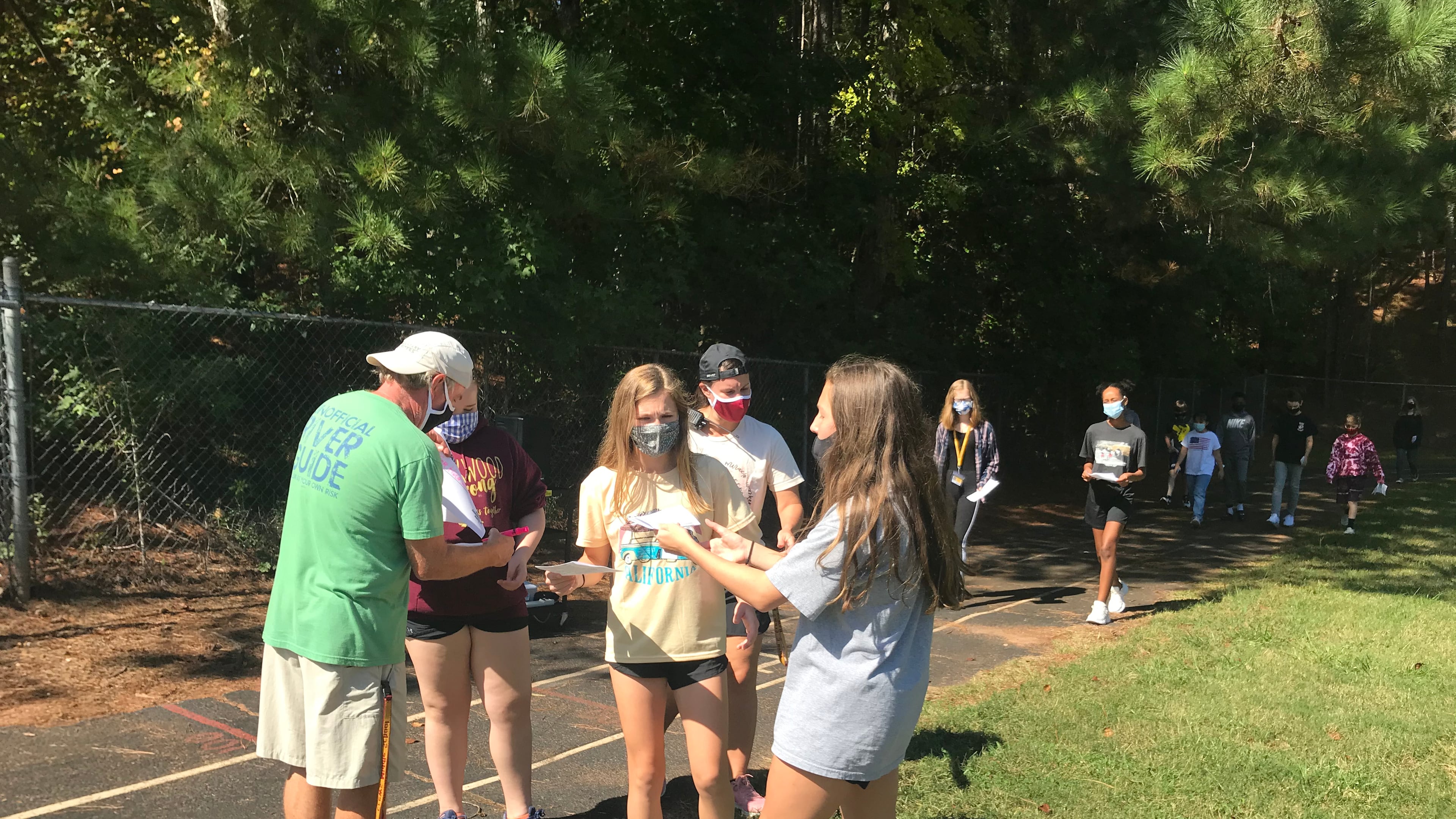 Students at Crews Middle School have their participation forms checked off during a recent 3-mile walk to promote inclusiveness.