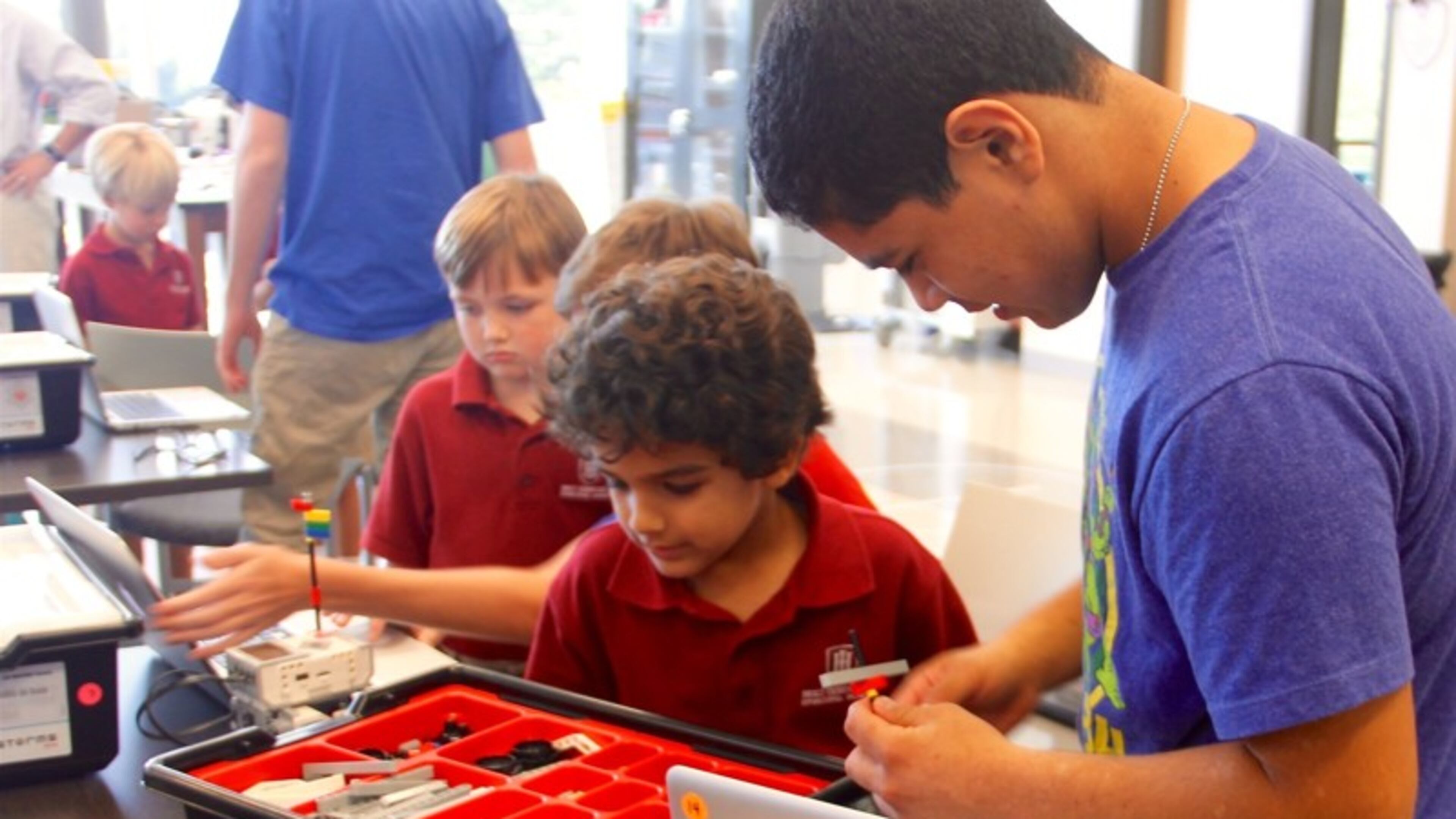 A junior from Holy Innocents' Upper School works with a kindergartner from the Primary School inside of a STEM robotics lab. Holy Innocents' Episcopal School is hosting its "STEMsational" camp on Saturday, Nov. 5.