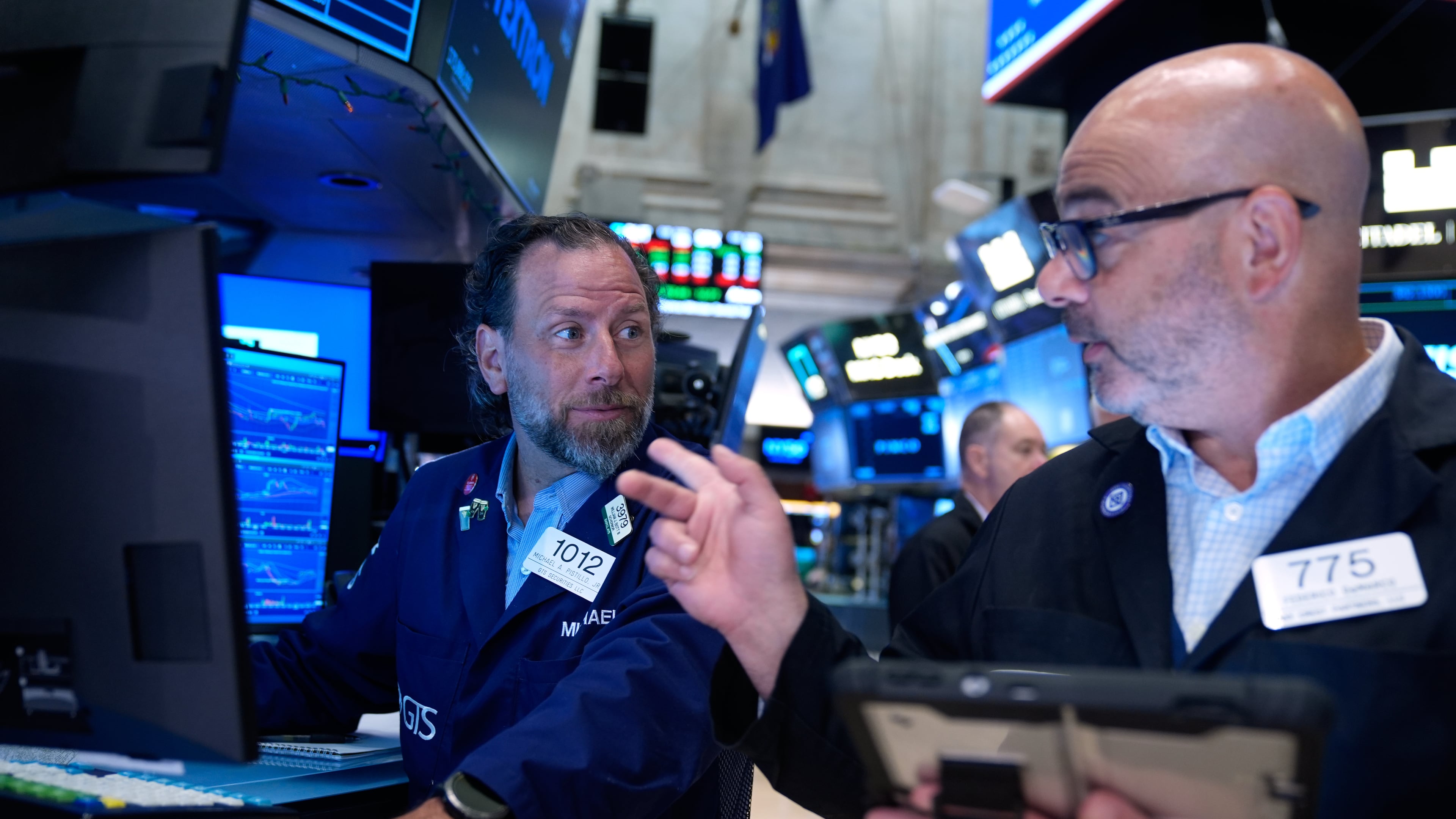Michael Pistillo, left, and Federico DeMarco work on the floor at the New York Stock Exchange in New York, Monday, July 6, 2026. (AP Photo/Seth Wenig)