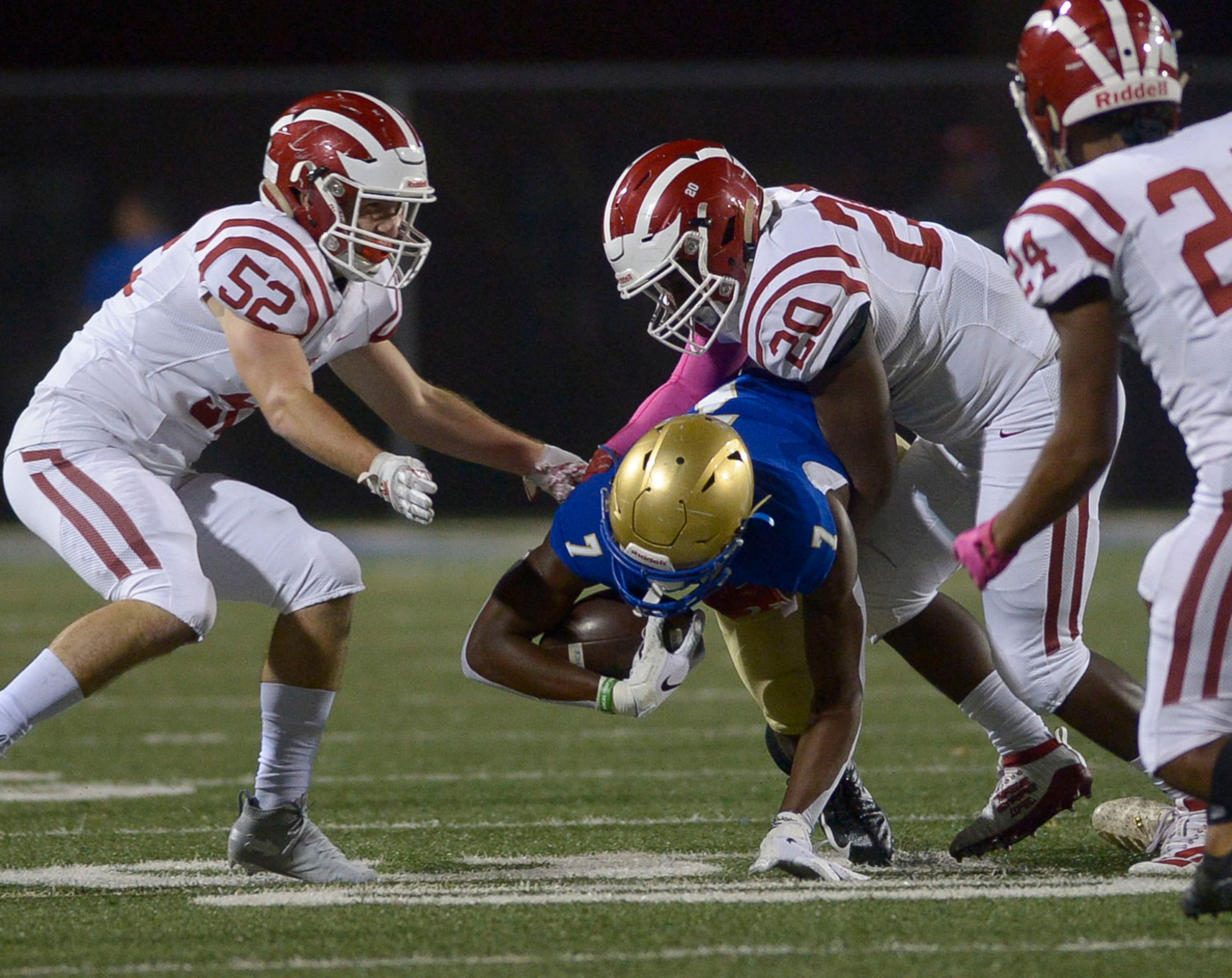 Hillgrove linebackers Zack Parker (52) and Jourdan Smith (20) tackle McEachern running back De'Amare Chambers (7) in the first half of Friday's game at McEachern. (Daniel Varnado/Special)