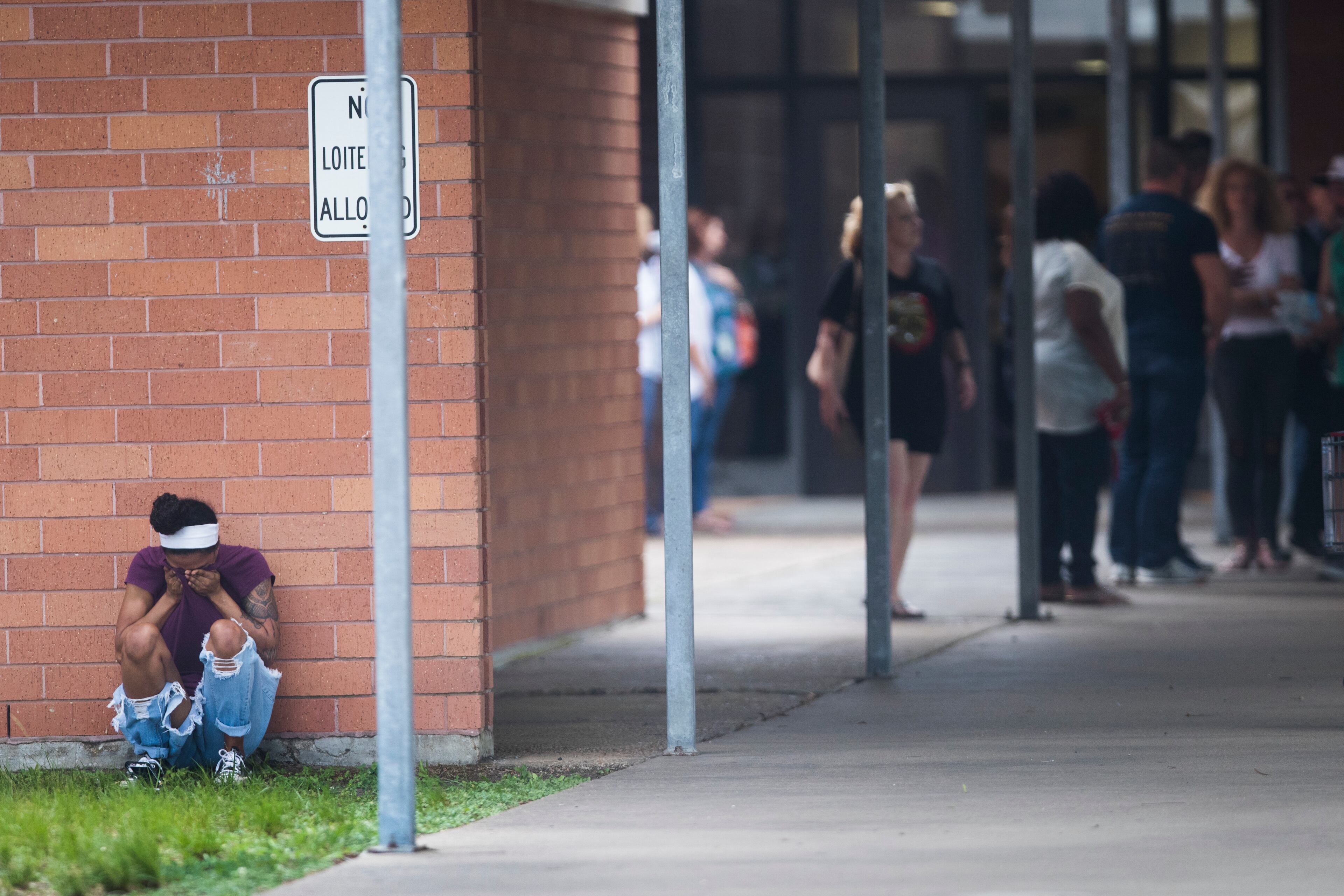 People gather by the Barnett Intermediate School where parents are gathering to pick up their children following a shooting at Santa Fe High School Friday, May 18, 2018, in Santa Fe, Texas. (Marie D. De Jesus/Houston Chronicle via AP)