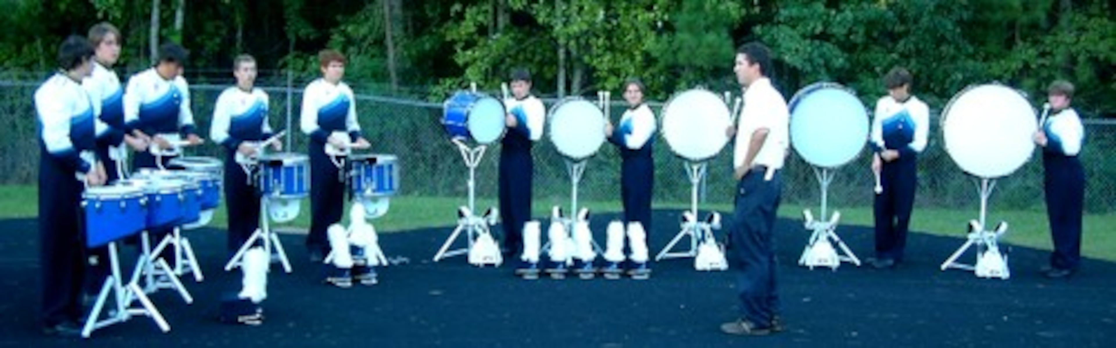 Newnan High 2007 Drumline in warmup at an Exhibition. From left: Tenors: Andrew Collins, Jake Hand, Snares: Dakota Kaplan, Andrew Bellisle, Spencer Jackson, Bass Drums: Levi Higgins, Henry Colomb, Jeremy Young, Cody Spradlin, Bruce Hudson, Percussion Instructor: Josh Roberts.