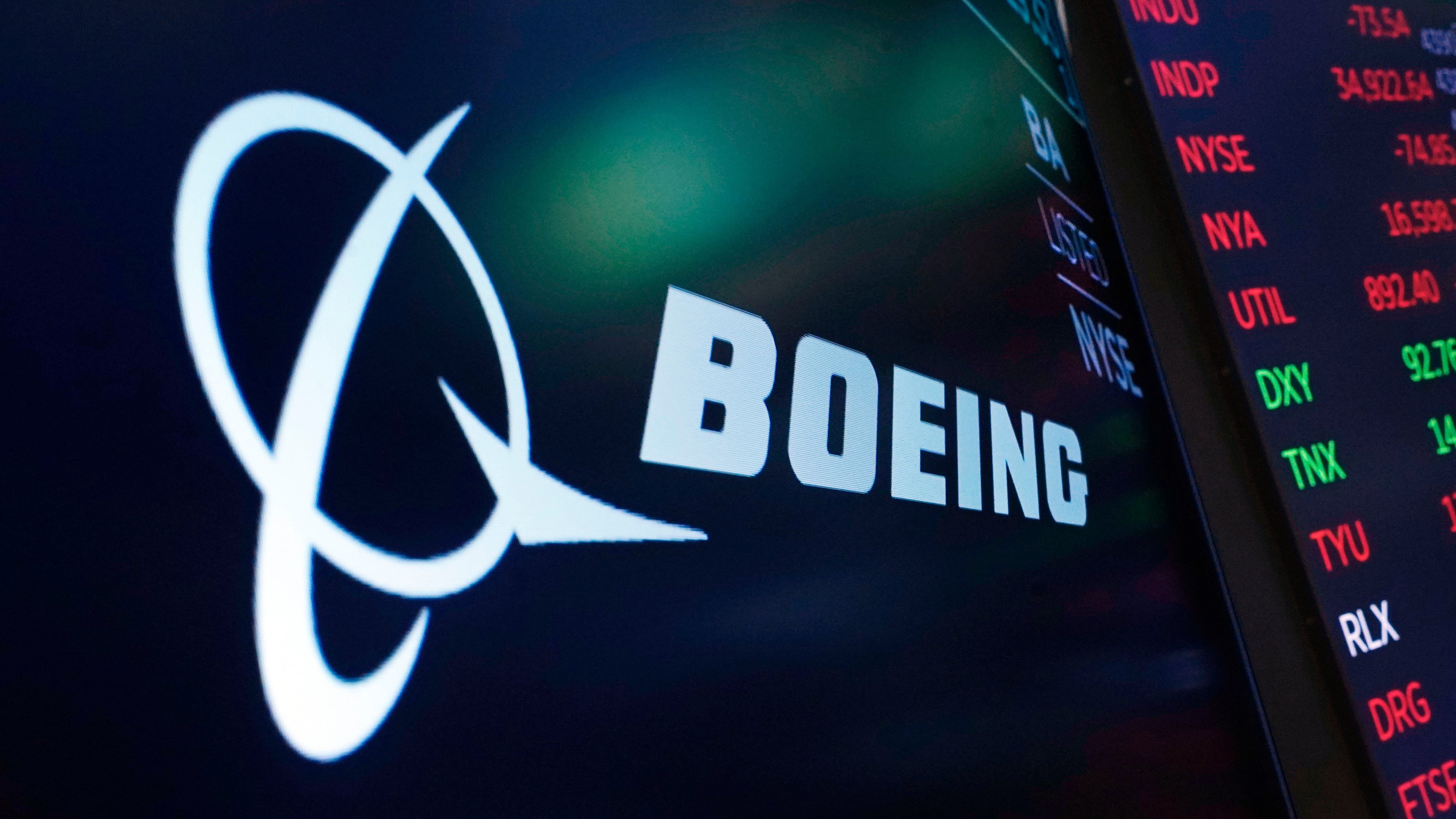 FILE - The logo for Boeing appears on a screen above a trading post on the floor of the New York Stock Exchange, July 13, 2021. (AP Photo/Richard Drew, File)