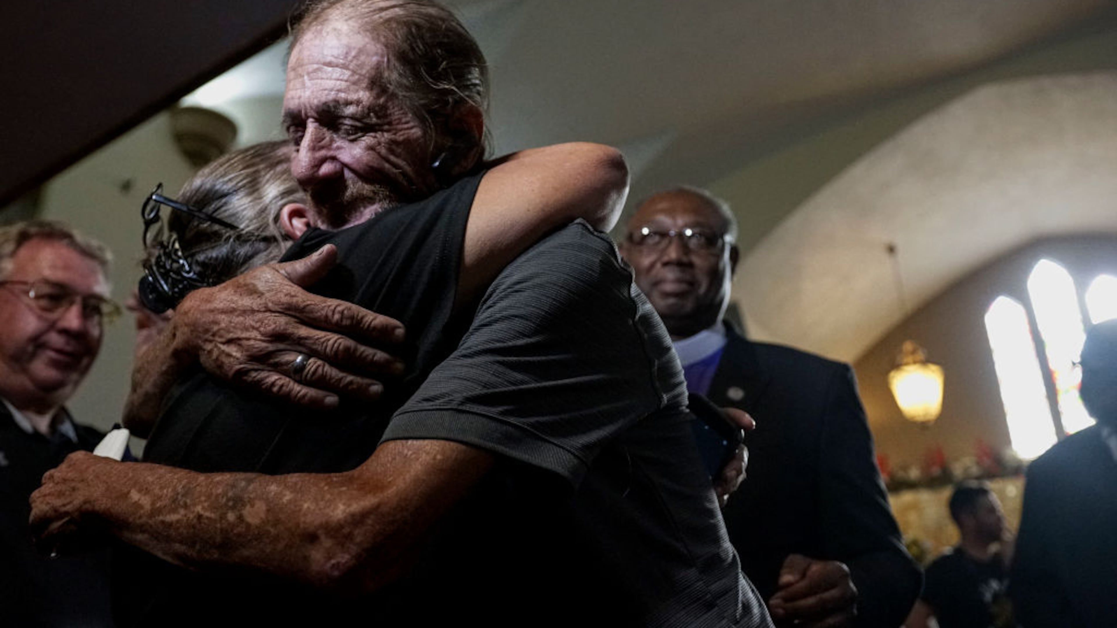 EL PASO, TX - AUGUST 16: Antonio Basco greets well wishers to a public memorial for his wife, Margie Reckard, on August 16, 2019 in El Paso, Texas. Reckard was one of 22 killed during the Walmart shooting in El Paso on August 3rd. Basco invited the public to attend the memorial in her honor and has laid fresh flowers everyday since the shooting at a make-shift memorial outside the outlet. (Photo by Sandy Huffaker/Getty Images)