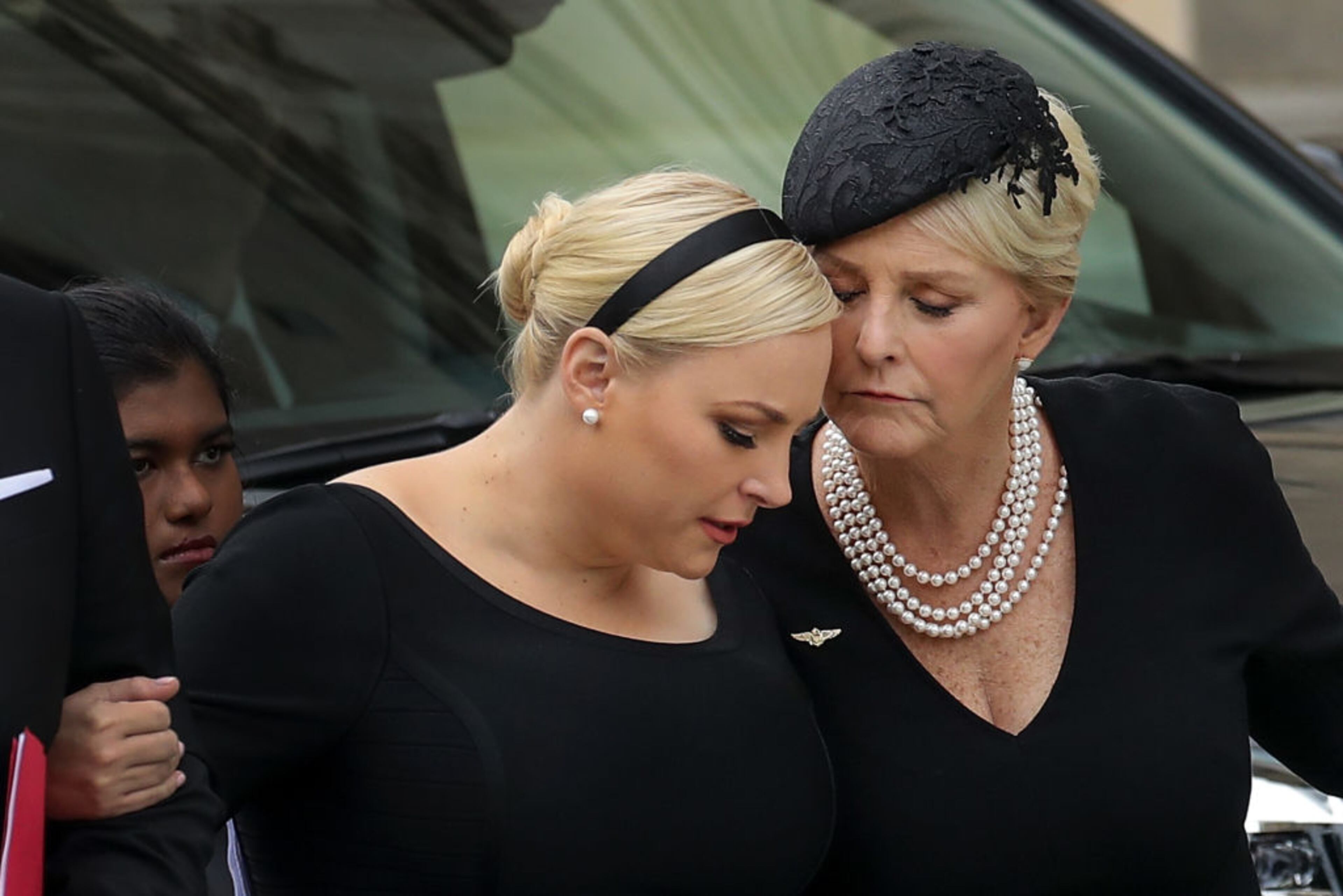WASHINGTON, DC - SEPTEMBER 1: Meghan McCain and her mother Cindy McCain embrace as the casket of the late Senator John McCain arrives at the Washington National Cathedral for the funeral service for McCain, September 1, 2018 in Washington, DC. Former presidents Barack Obama and George W. Bush are set to deliver eulogies for McCain in front of the 2,500 invited guests. McCain will be buried on Sunday at the U.S. Naval Academy Cemetery. (Photo by Drew Angerer/Getty Images)