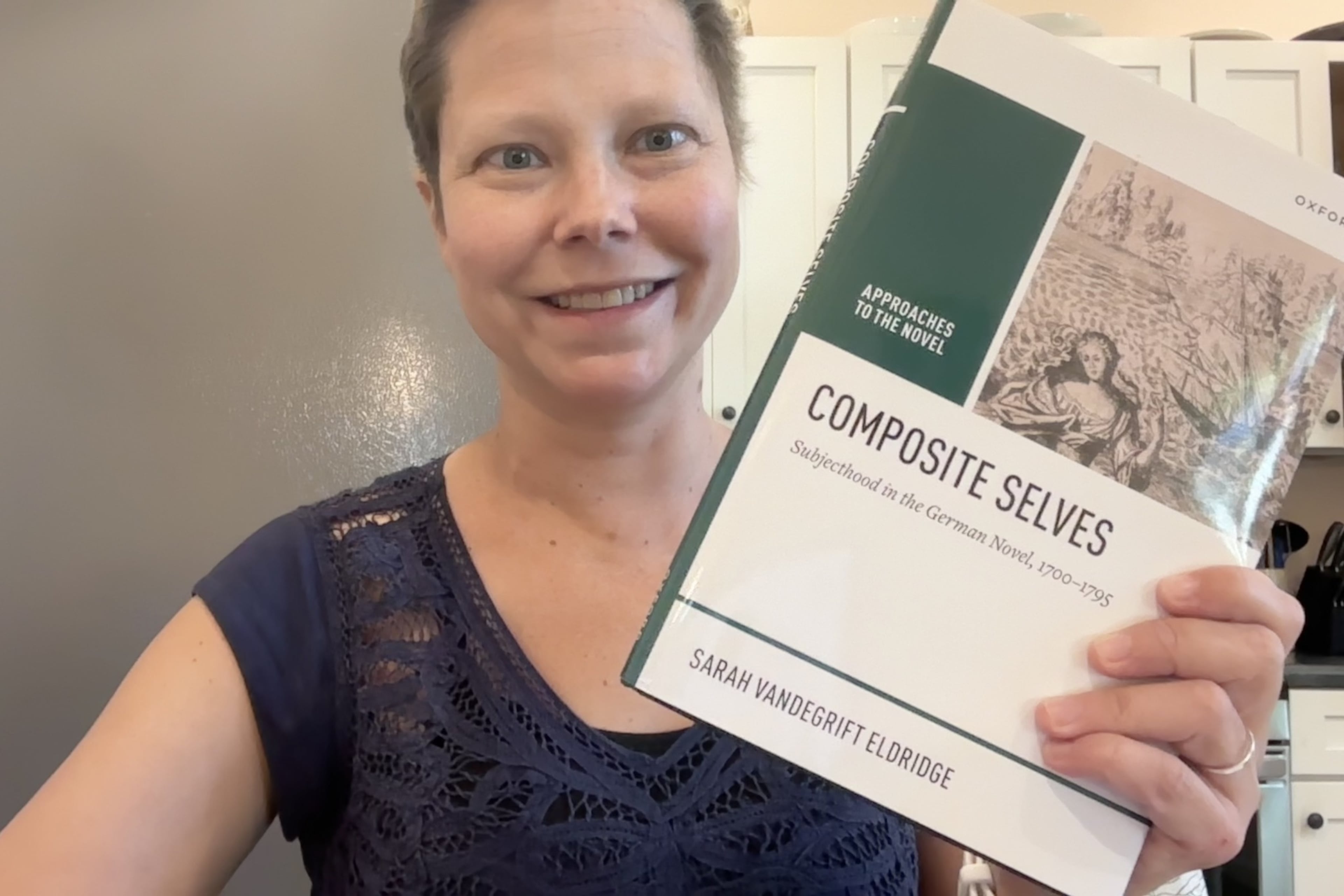 Sarah Eldridge poses in a selfie on Sept. 12, 2025, with her second academic publication "Composite Selves, Subjecthood in the German Novel, 1700-1795.” During this time period, Sarah was undergoing chemotherapy treatment. She posted on Facebook: “There have been long periods when I truly thought this day would never come, and while it seems a bit off to post about personal victories while the world is an unrelenting dumpster fire, I'm genuinely SO happy that I am still alive to see the publication of my second book, I'm really proud of the work I put into it, and I'm beyond grateful to everyone who helped me get to this point. This book has a LONG acknowledgments section!” (Family photo)