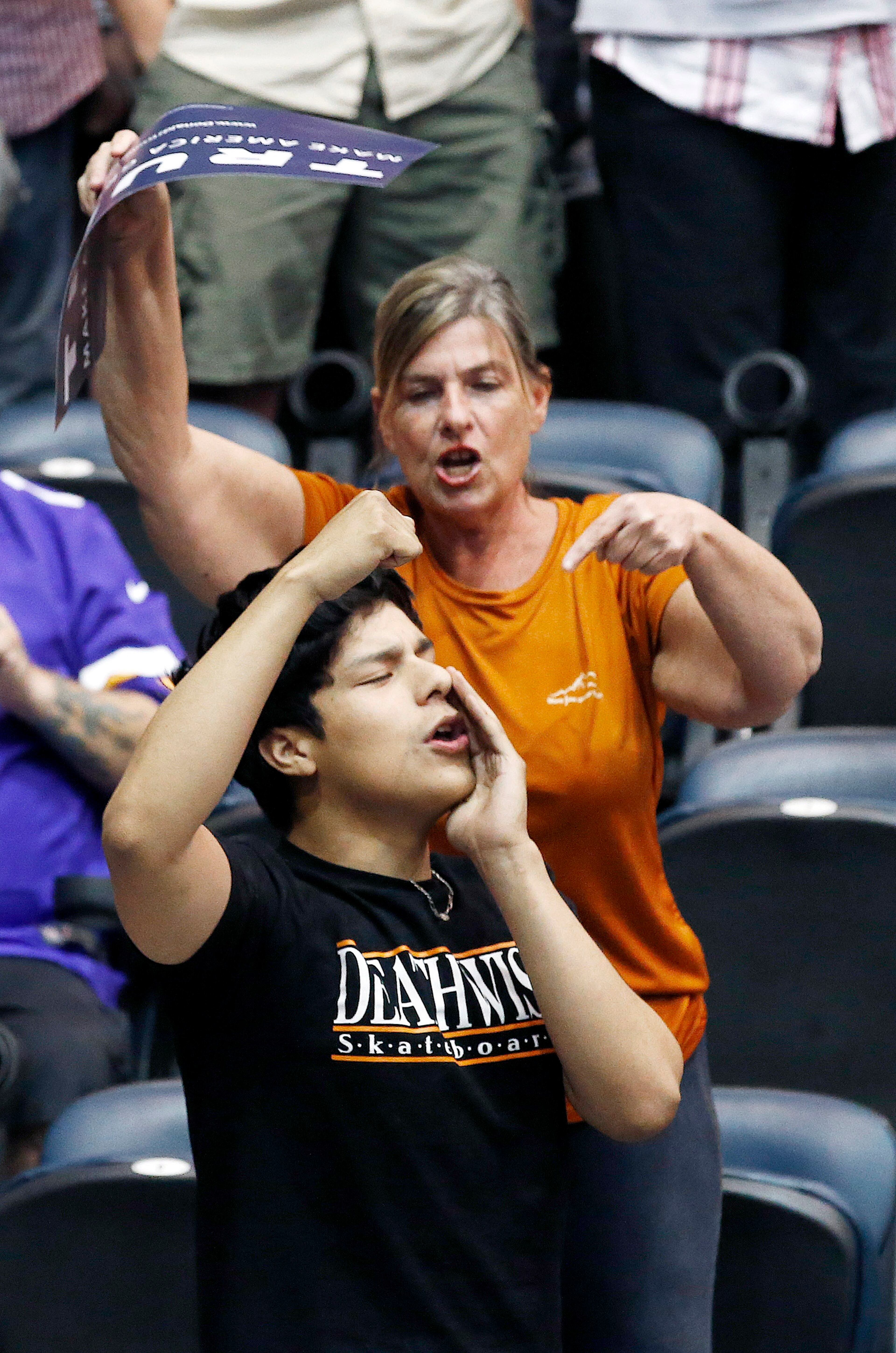 A supporter of Republican presidential candidate Donald Trump, top, points to a protester, bottom, who tries to stop the candidate from speaking during a campaign rally Saturday, March 19, 2016, in Tucson, Ariz. (AP Photo/Ross D. Franklin)