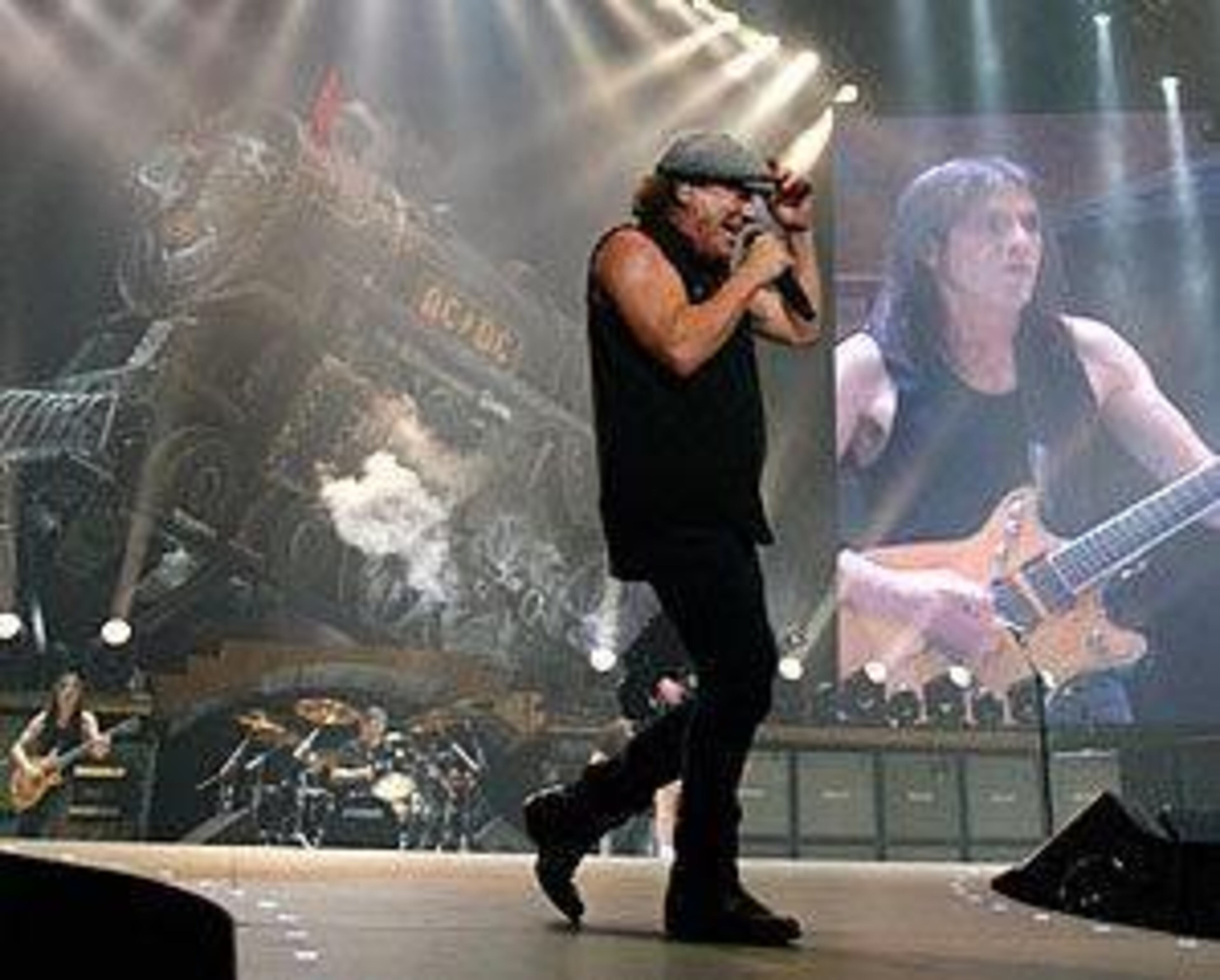 Malcolm Young - in the background, as usual, on the video screen - performing at Philips Arena in 2008. Photo: MIKKI K. HARRIS / mkharris@ajc.com