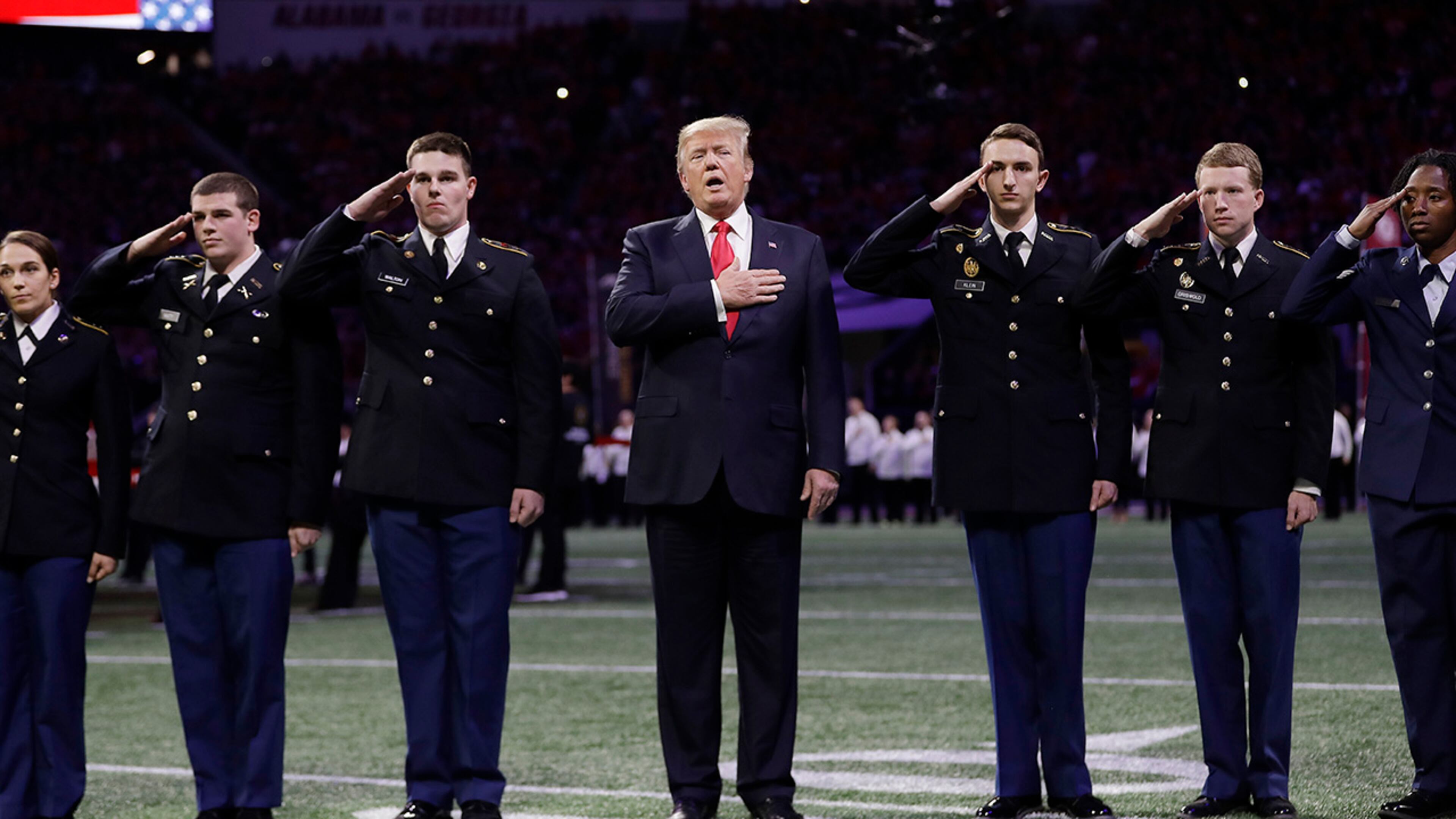 President Donald Trump sings the national anthem before the NCAA college football playoff championship game between Georgia and the AlabamaMonday, Jan. 8, 2018, in Atlanta. (AP Photo/David J. Phillip)