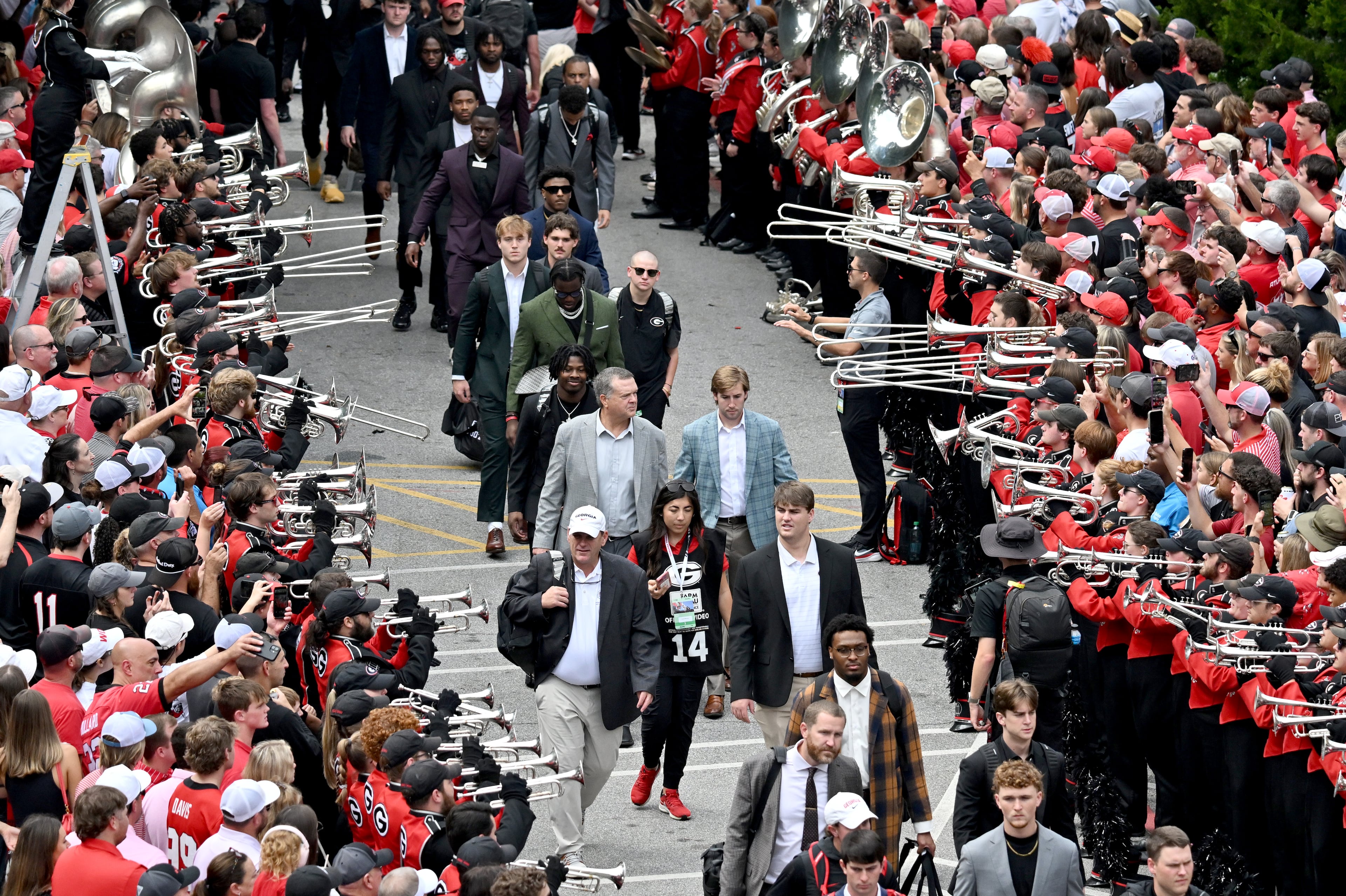 Georgia players and coaching staff arrive during the Dawg Walk before an NCAA football game against Mississippi at Sanford Stadium, Saturday, October 18, 2025, in Athens. (Hyosub Shin/AJC)