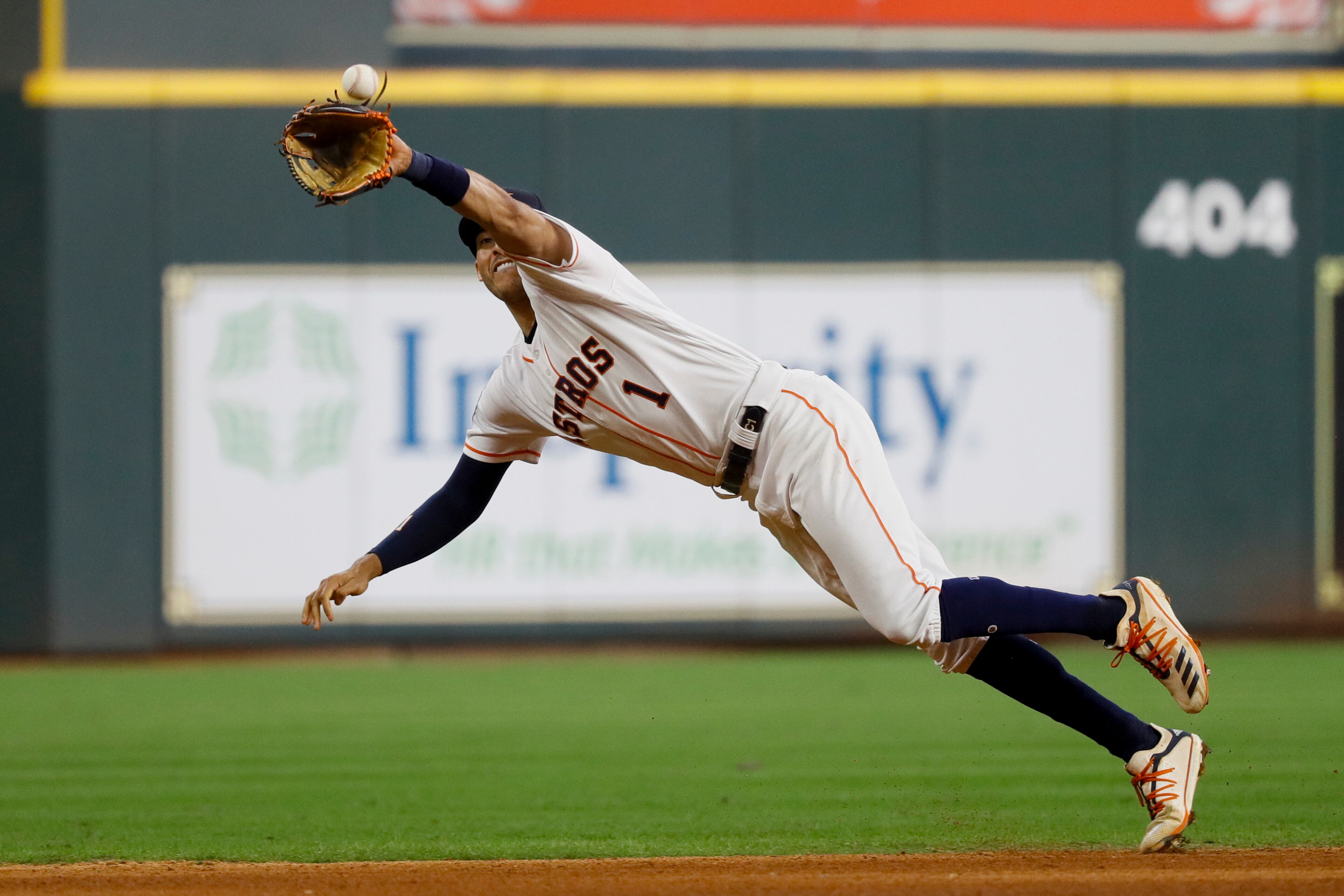 Houston Astros shortstop Carlos Correa catches a line drive by Washington Nationals' Howie Kendrick during the fourth inning of Game 1 of the baseball World Series Tuesday, Oct. 22, 2019, in Houston. (AP Photo/Matt Slocum)