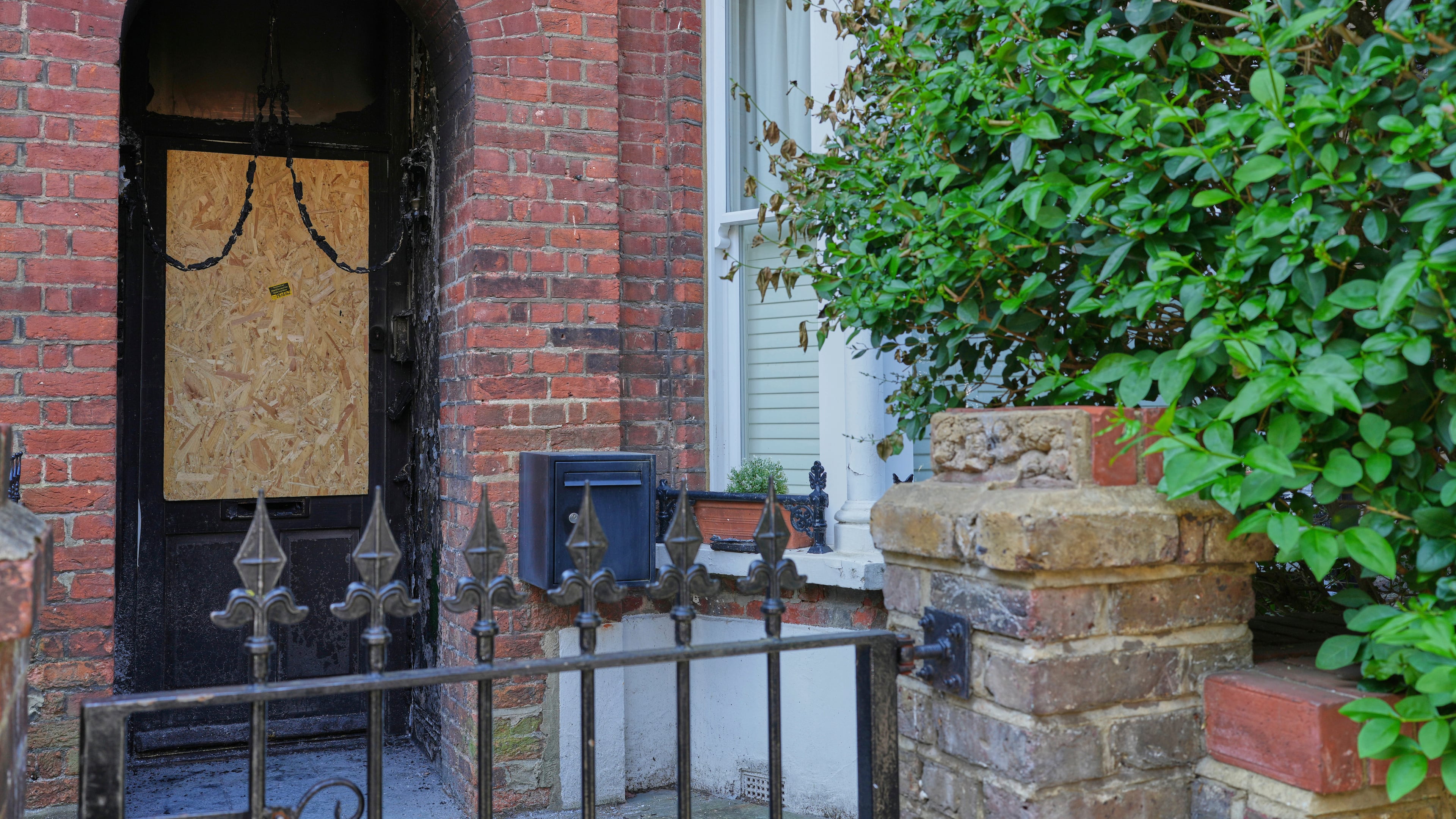 FILE - Fire damage in the doorway of a house belonging to British Prime Minister Keir Starmer in Kentish Town in London, May 13, 2025. (AP Photo/Kirsty Wigglesworth, File)