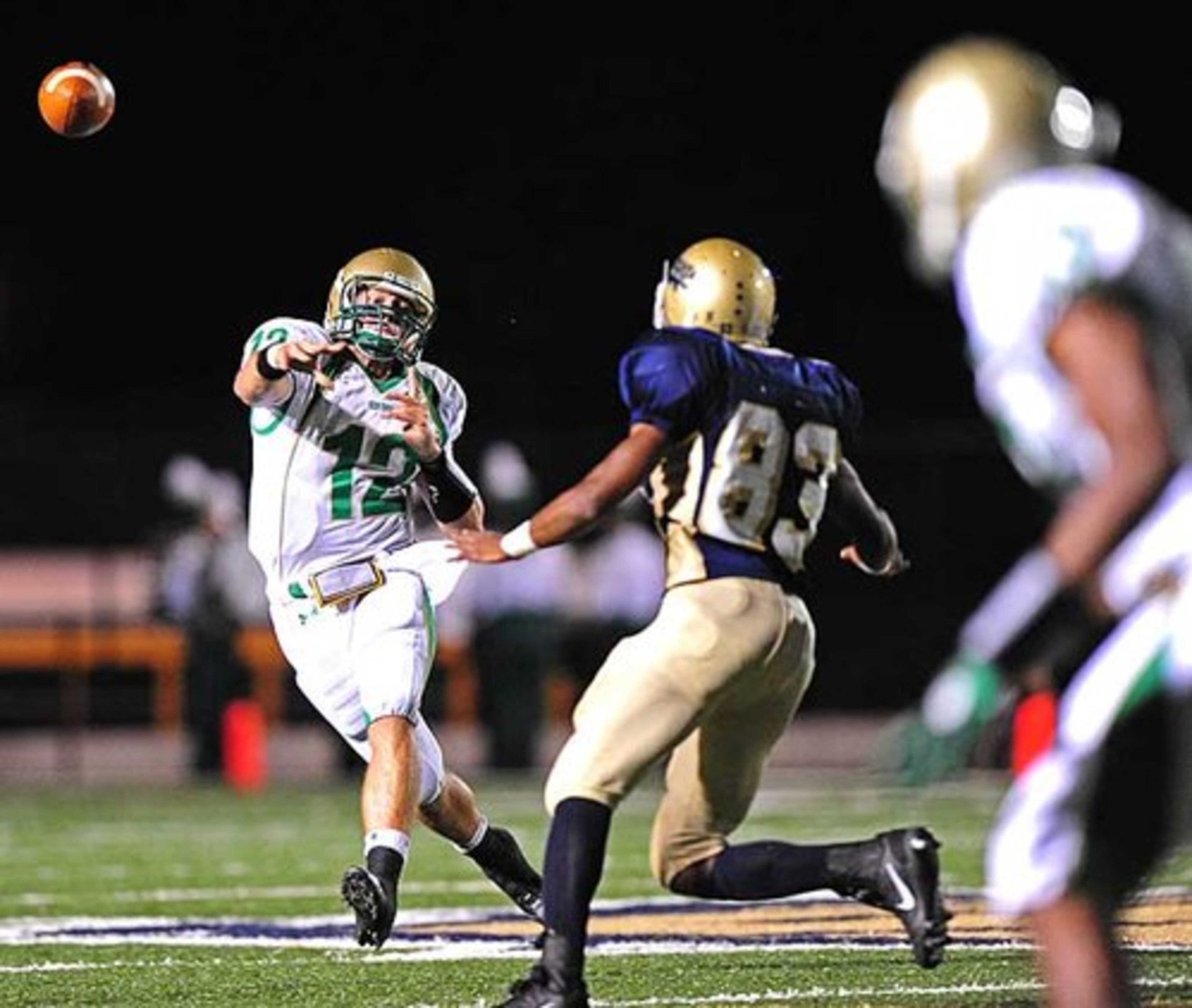 Buford quarterback Michael May (12) eludes a Decatur defender, getting off the pass.