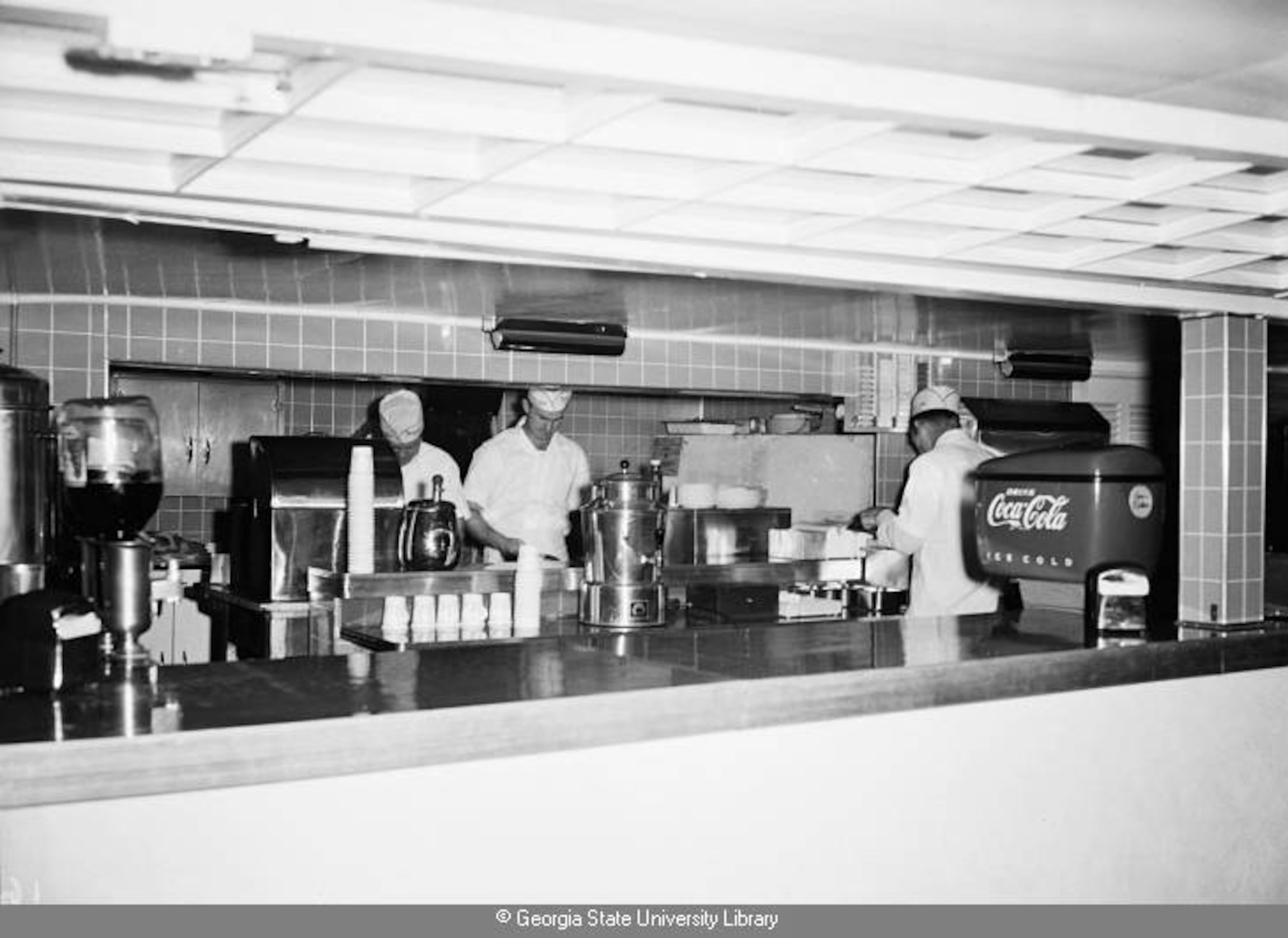 1951 -- Workers at the Peachtree Drive-In Theatre's concession stand do a brisk business. LANE BROS. PHOTOGRAPHS / GSU