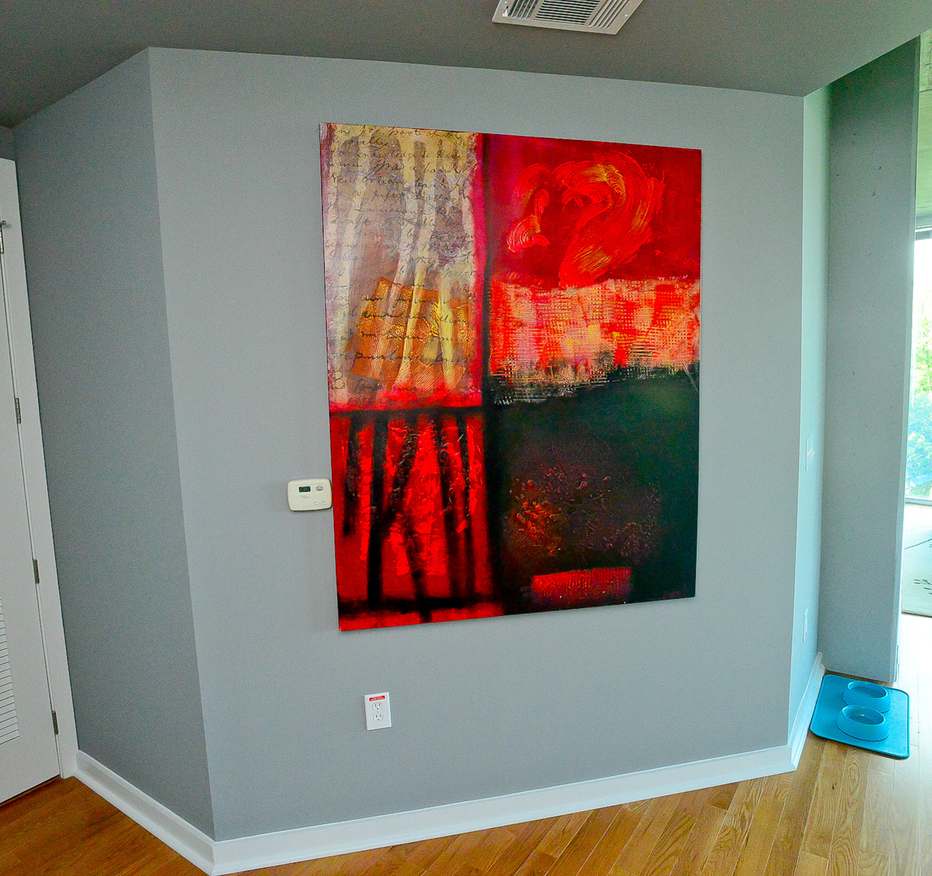 After selecting gray tones for his condo, Jason Raymond hung multi-colored artwork to break up the wall color. Some pieces relate to his passion for wine and his career as a sommelier.