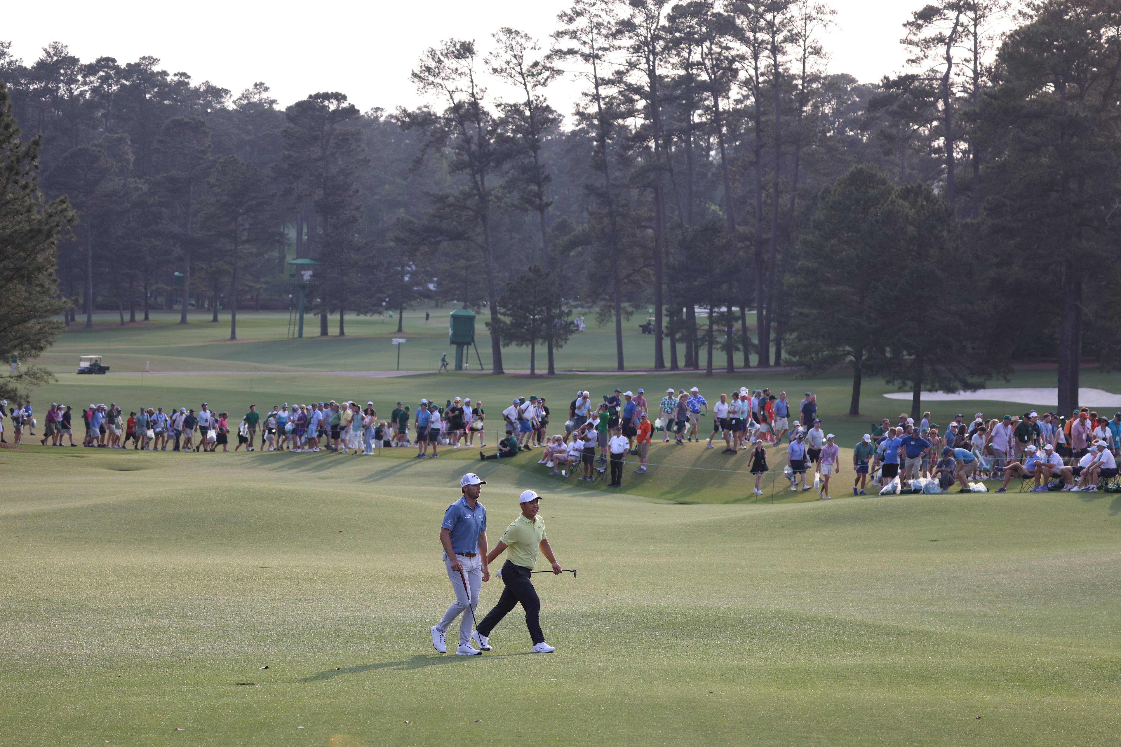 Sam Burns, left and Tom Kim walk up 18th fairway during first round of the 2023 Masters Tournament at Augusta National Golf Club, Thursday, April 6, 2023, in Augusta, Ga. (Jason Getz / Jason.Getz@ajc.com)