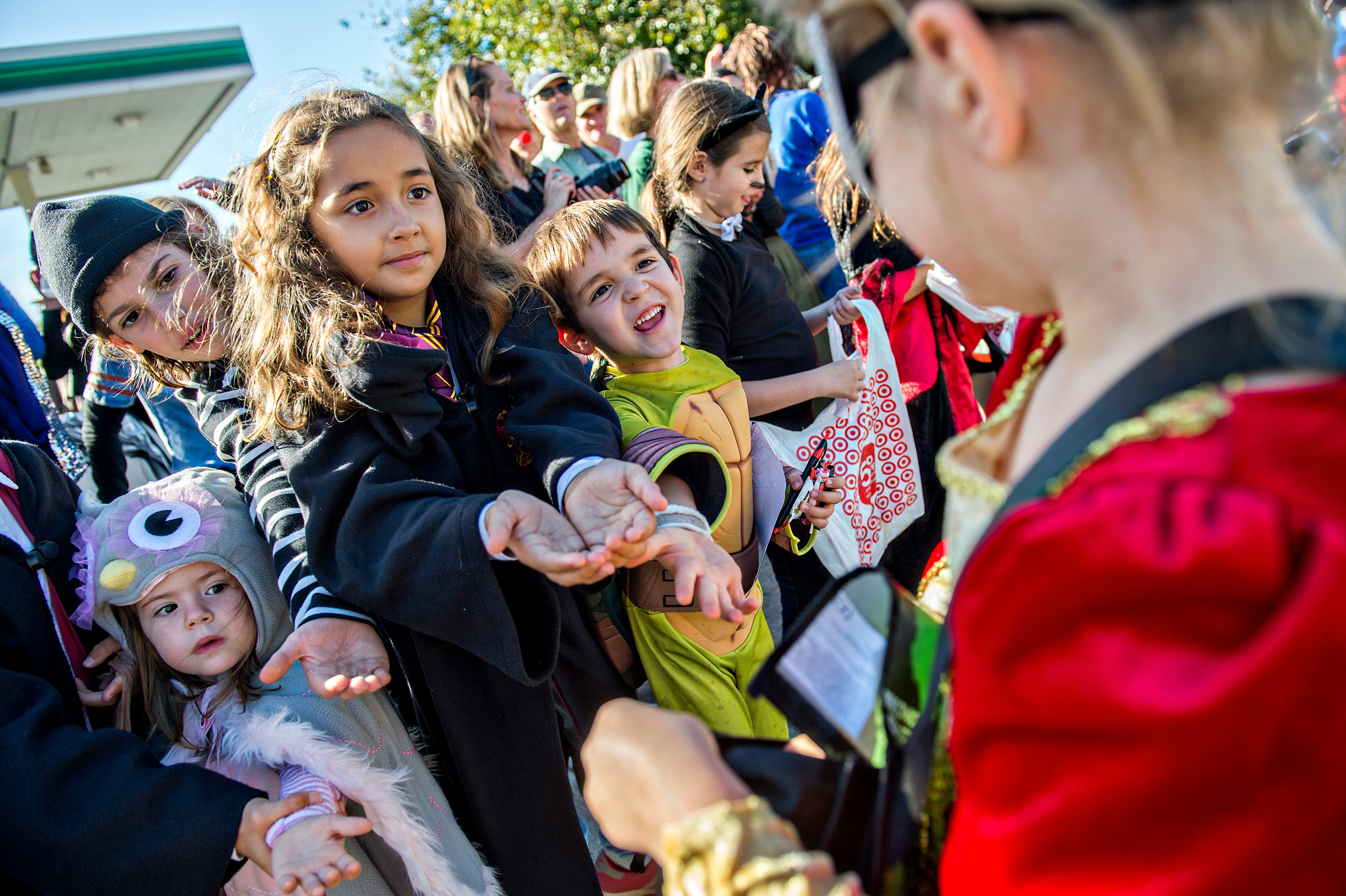 October 17, 2015 Atlanta - Stella Maximuk (left) and her brother Nico reach their hands out to try and get candy during the Little Five Points Halloween Parade in Atlanta on Saturday, October 17, 2015. The annual parade brought out tens of thousands of people to watch the antics. JONATHAN PHILLIPS / SPECIAL