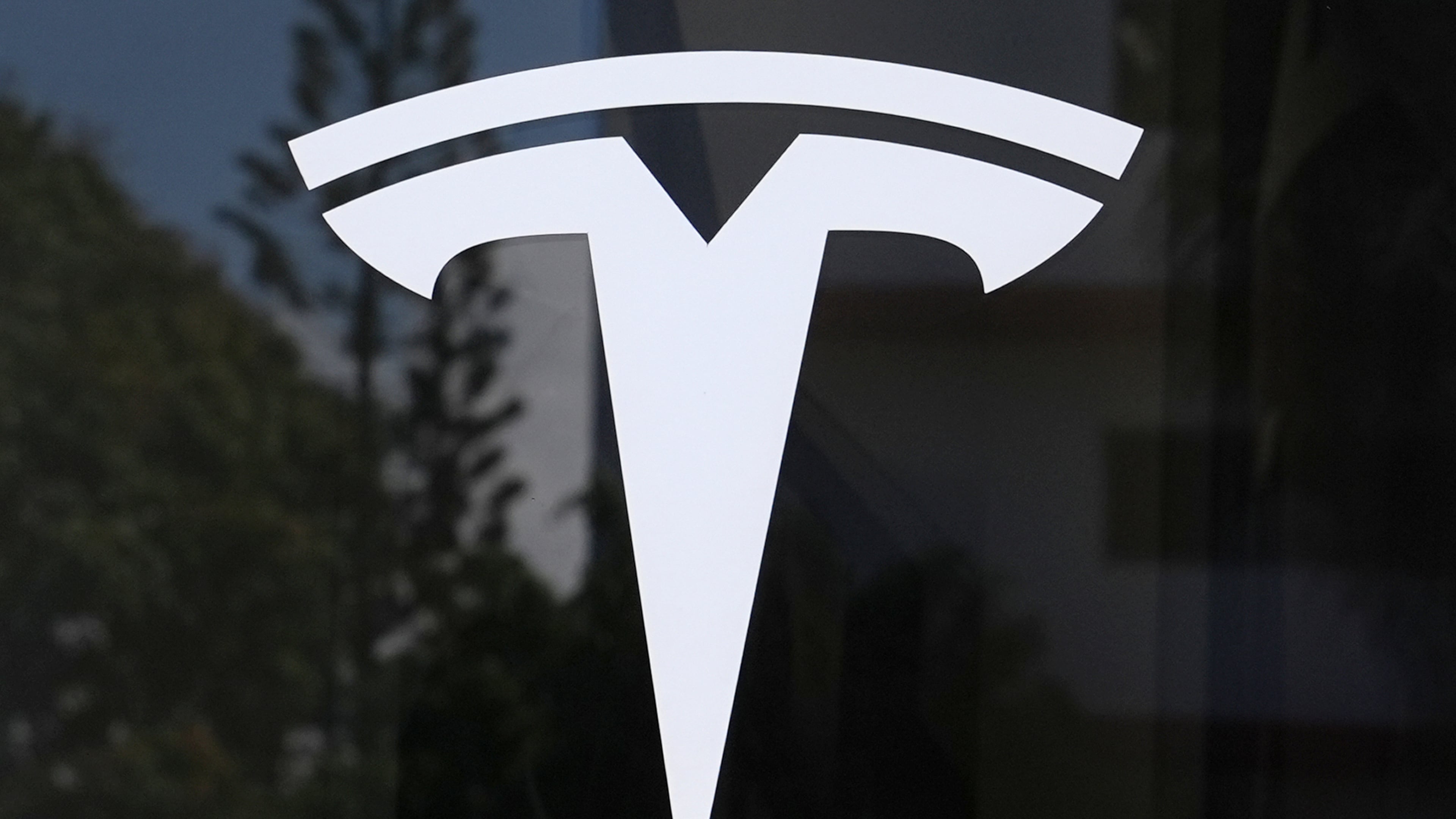 FILE - The Tesla logo is displayed at a Tesla dealership, Mar. 13, 2025, in Miami. (AP Photo/Lynne Sladky, File)