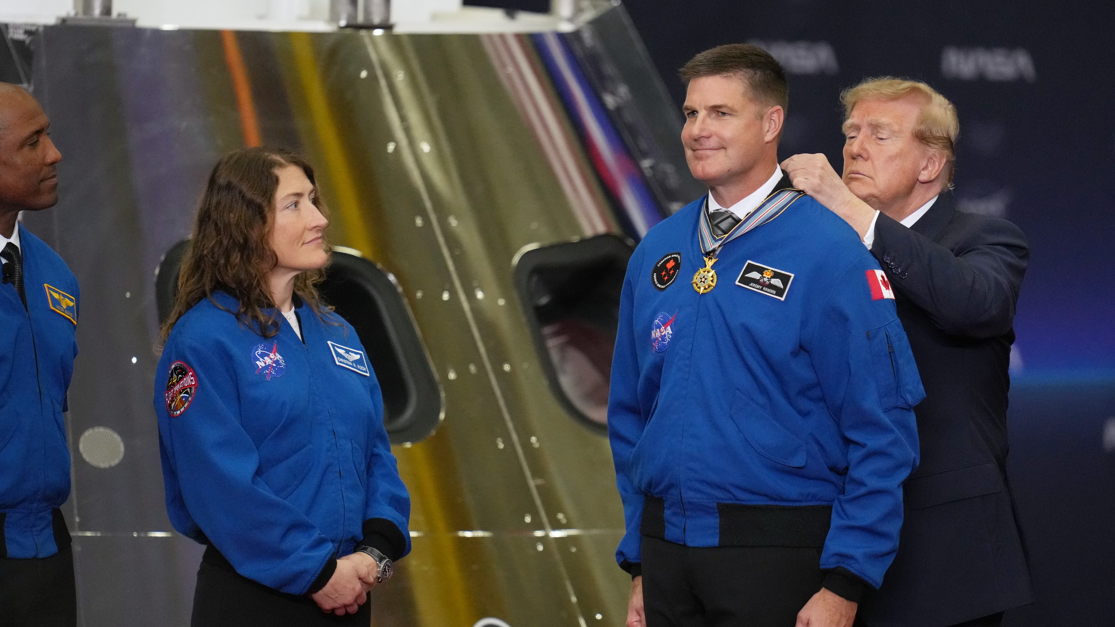 President Donald Trump participates in a Congressional Space Medal of Honor ceremony at NASA's Johnson Space Center, Friday, Aug. 28, 2026, in Houston, and puts a medal on Artemis II Astronaut and Mission Specialist, Jeremy Hansen. (AP Photo/Karen Warren)