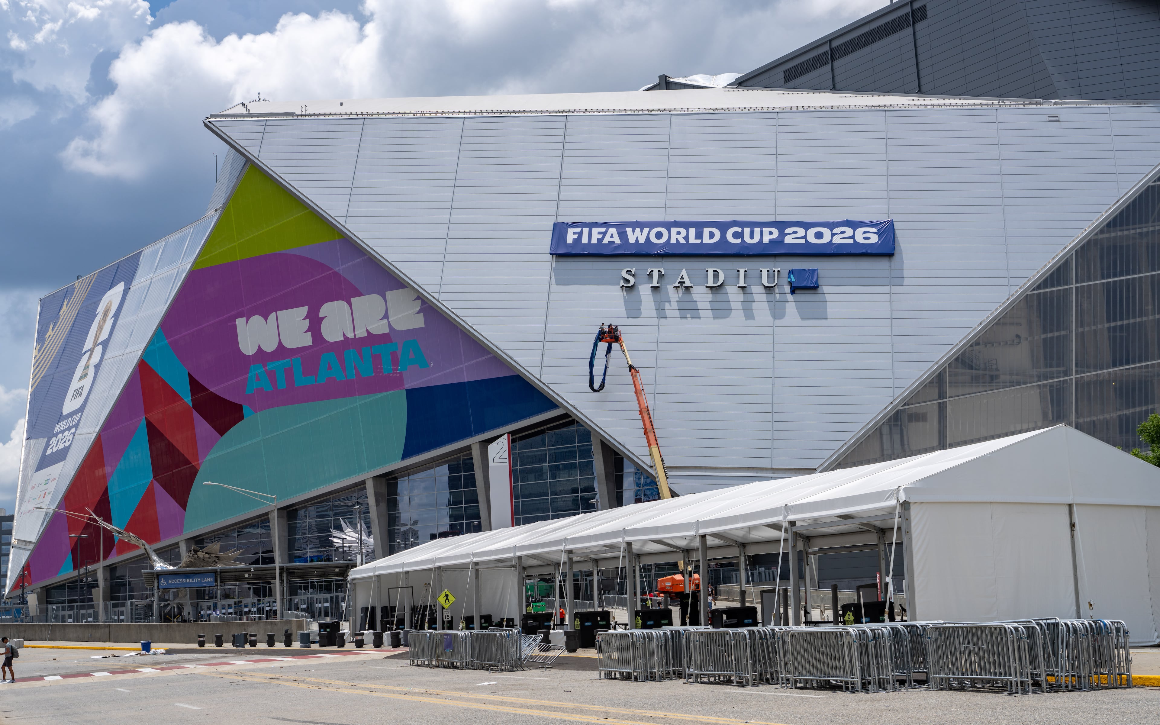 Workers remove a banner from Mercedes-Benz stadium on Friday, July 17, 2026. (Ben Hendren for the AJC)