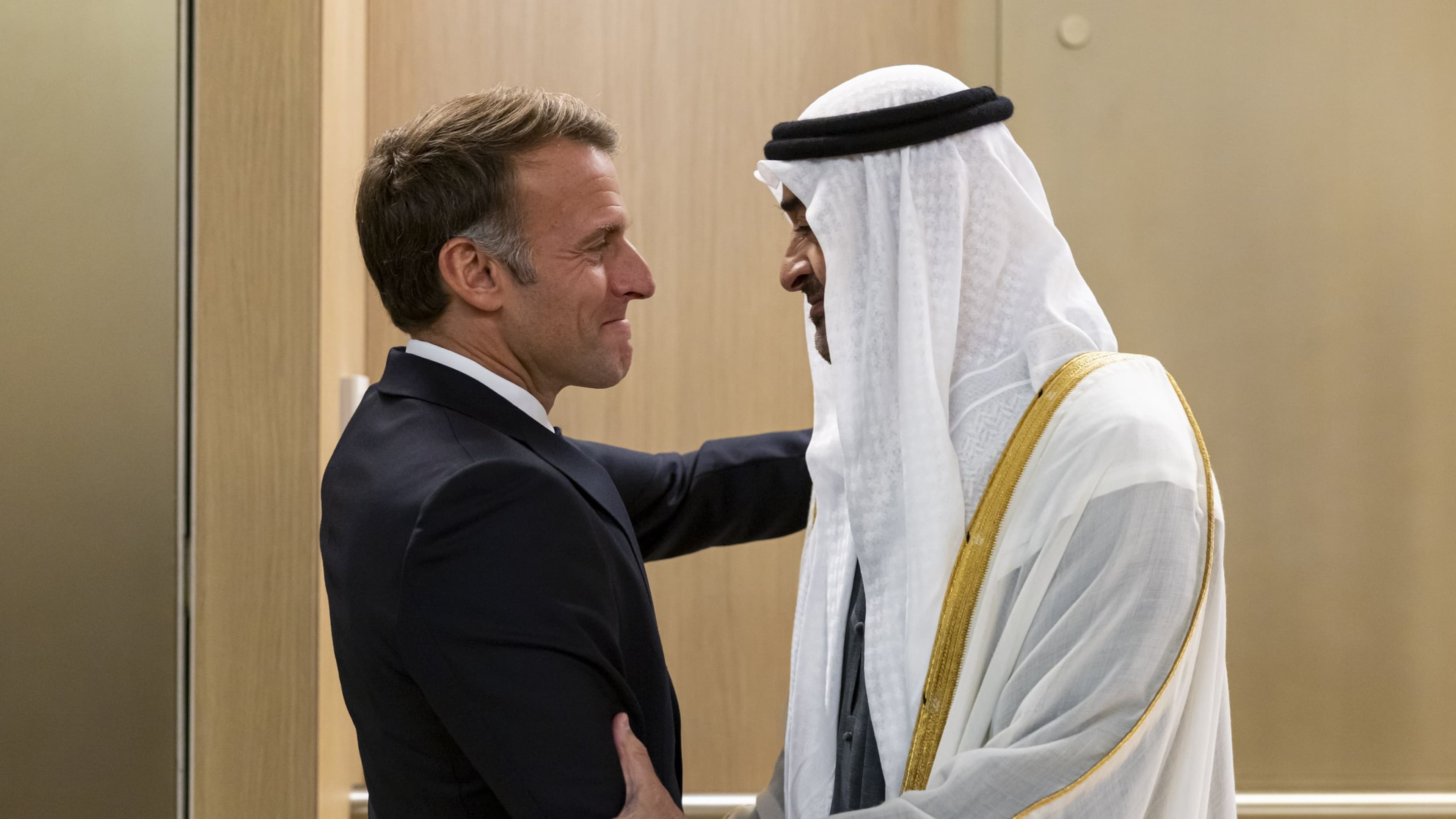 In this photograph released by the state-run WAM news agency, United Arab Emirates President Sheikh Mohammed bin Zayed Al Nahyan, right, greets French President Emmanuel Macron upon his arrival in Abu Dhabi, United Arab Emirates, Monday, Oct. 19, 2026. (WAM via AP)
